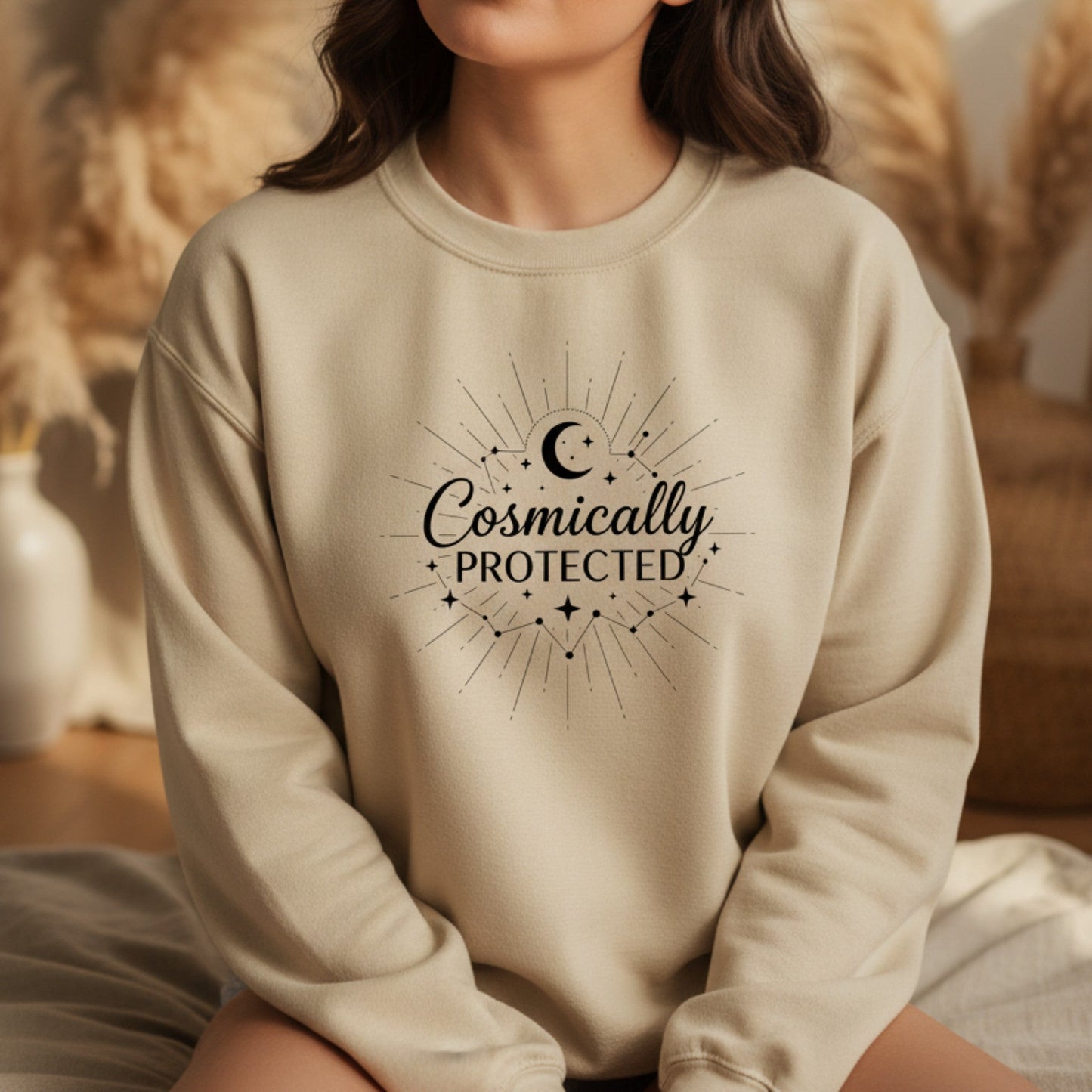 Sand neutral sweatshirt with black starburst moon design — earthy boho celestial crewneck for the woman who moves through life guided and grounded