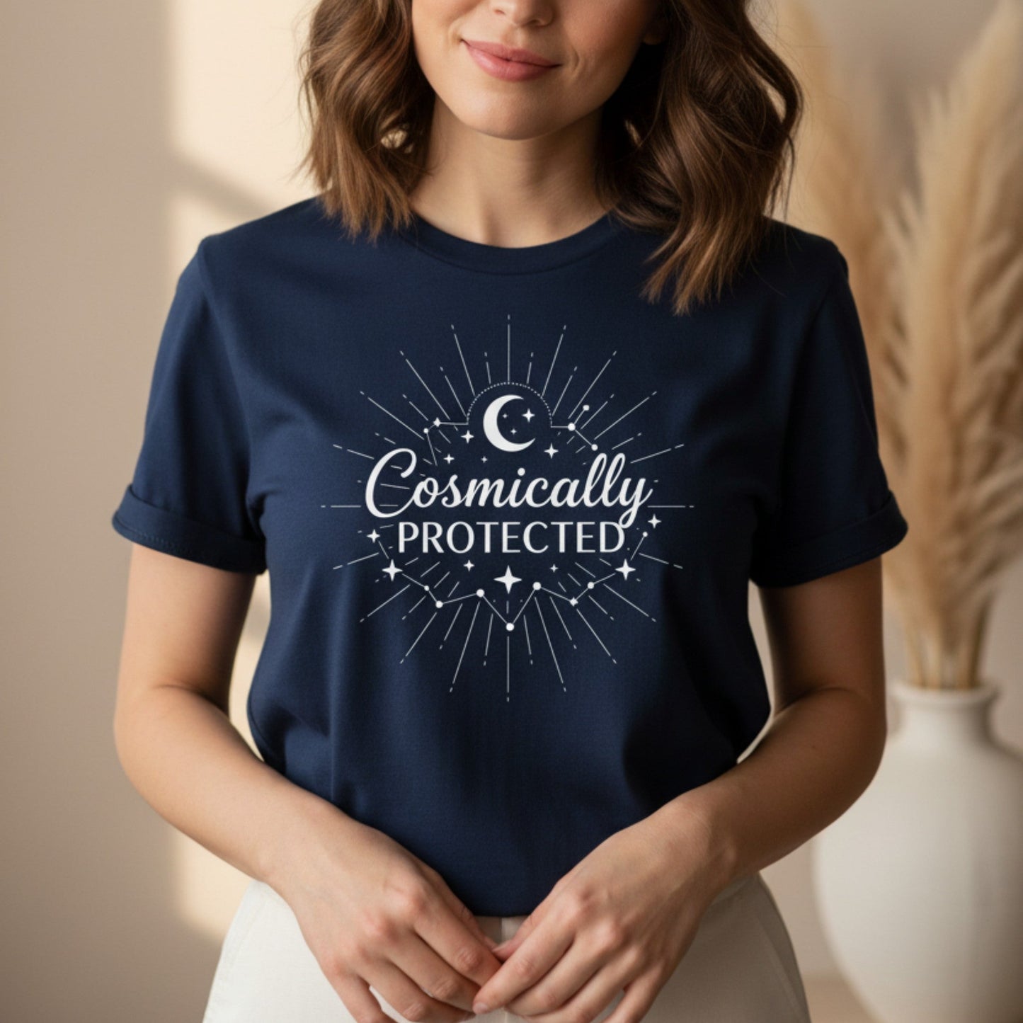 Navy blue cosmically protected graphic tee with white sunburst and crescent moon print — celestial spiritual gift for women who trust the universe to guide their path