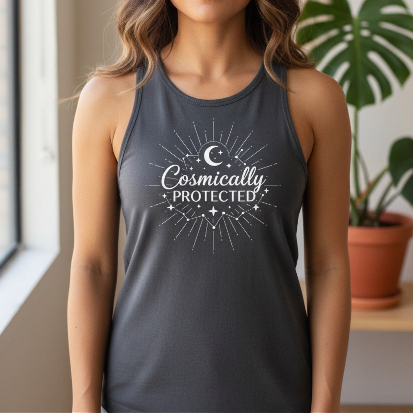 Dark gray cosmically protected racerback tank with white sunburst moon graphic — spiritual protection workout top for women who move through life guided and grounded