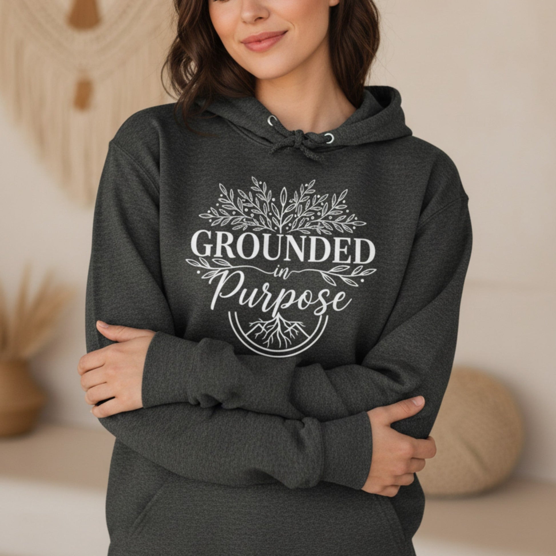 Woman wearing a dark heather grey Grounded In Purpose pullover hoodie — motivational gift for women who lead with intention
