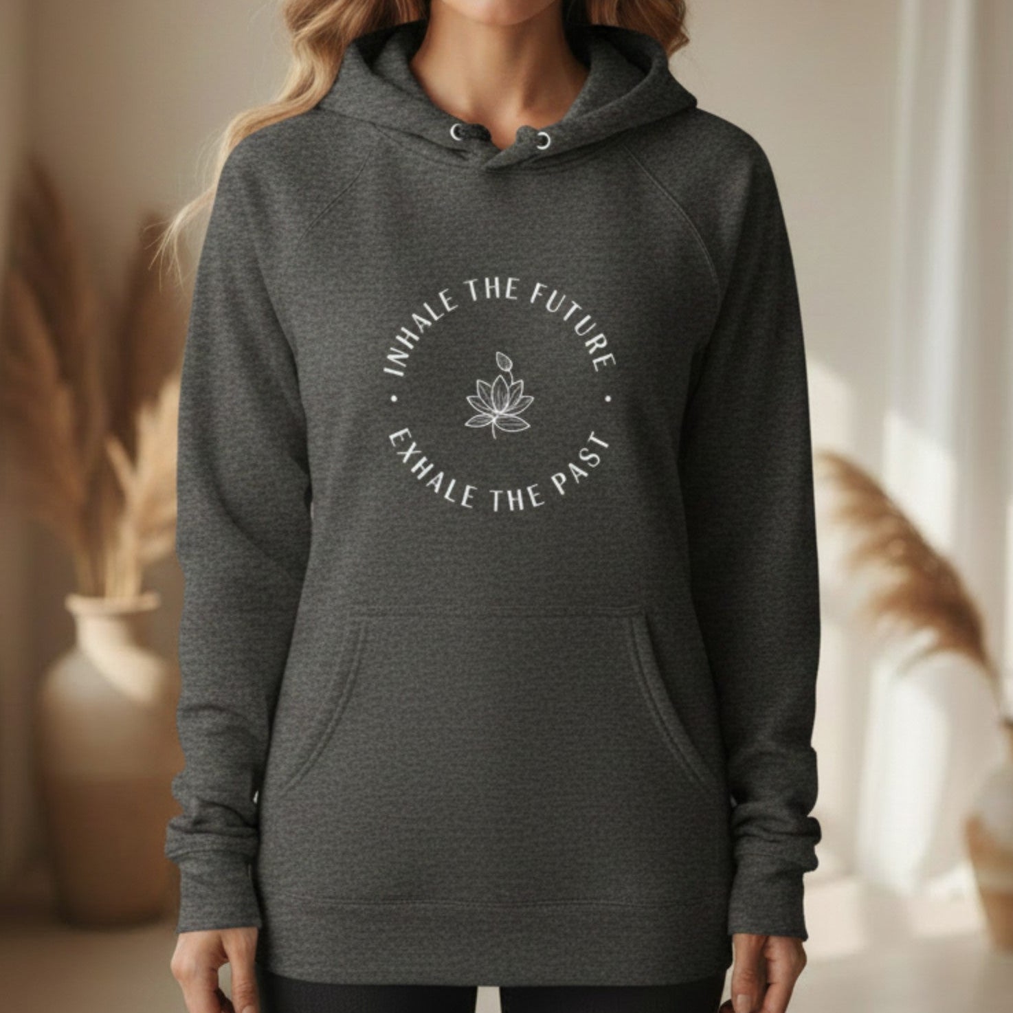 Dark heather gray Inhale the Future Exhale the Past hoodie with white lotus badge print — cozy mindfulness gift for the woman who breathes forward and releases what no longer serves her
