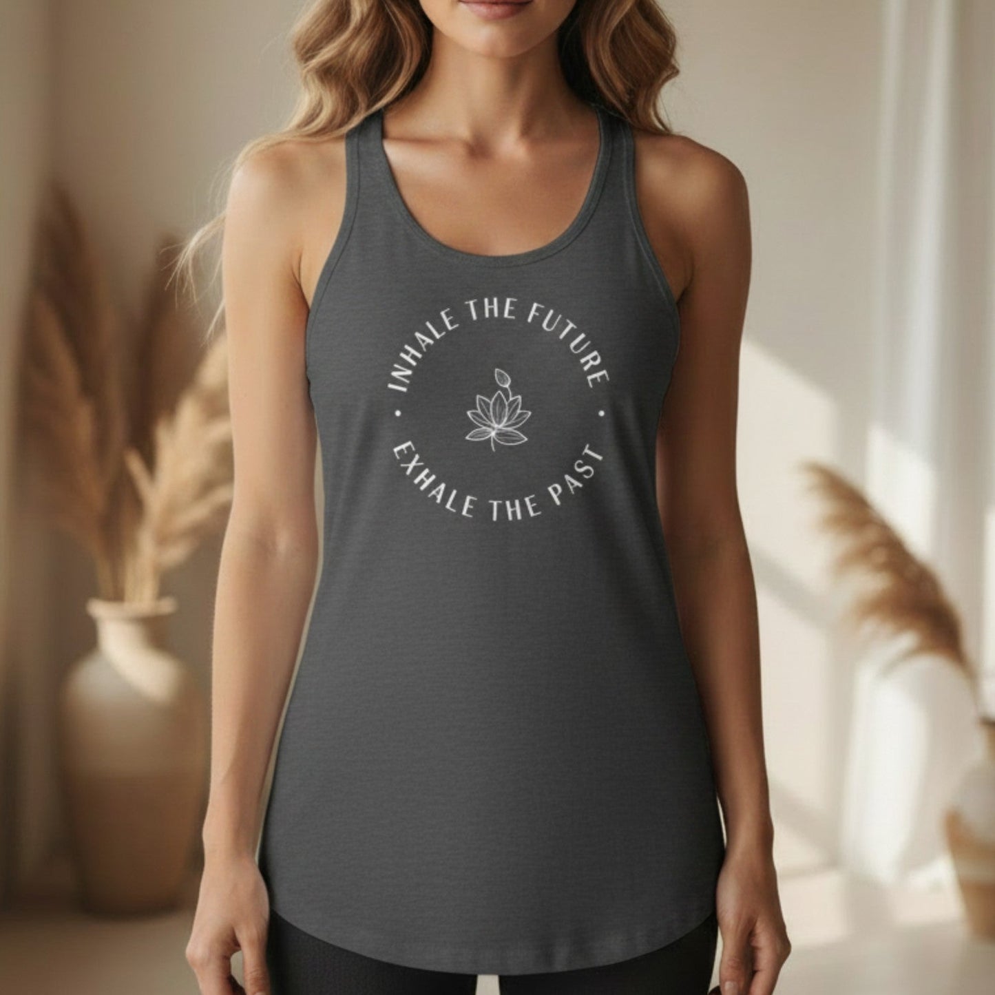 Dark gray Inhale the Future Exhale the Past racerback tank with white lotus badge print — mindfulness yoga gift for the woman who breathes forward and releases what no longer serves her