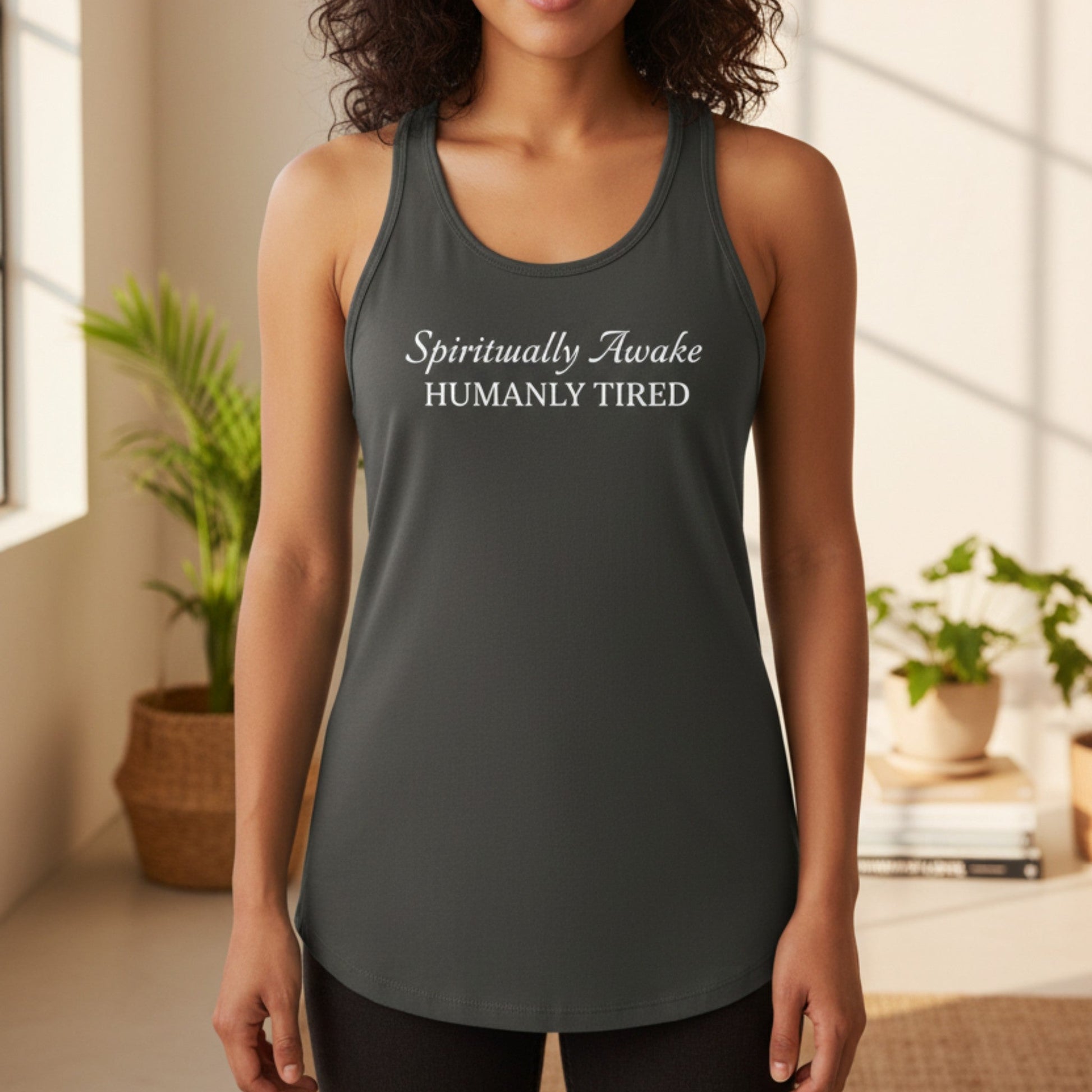 Dark gray Spiritually Awake Humanly Tired racerback tank with white script and serif print — funny spiritual gift for the woman who is deeply aligned and deeply in need of a nap