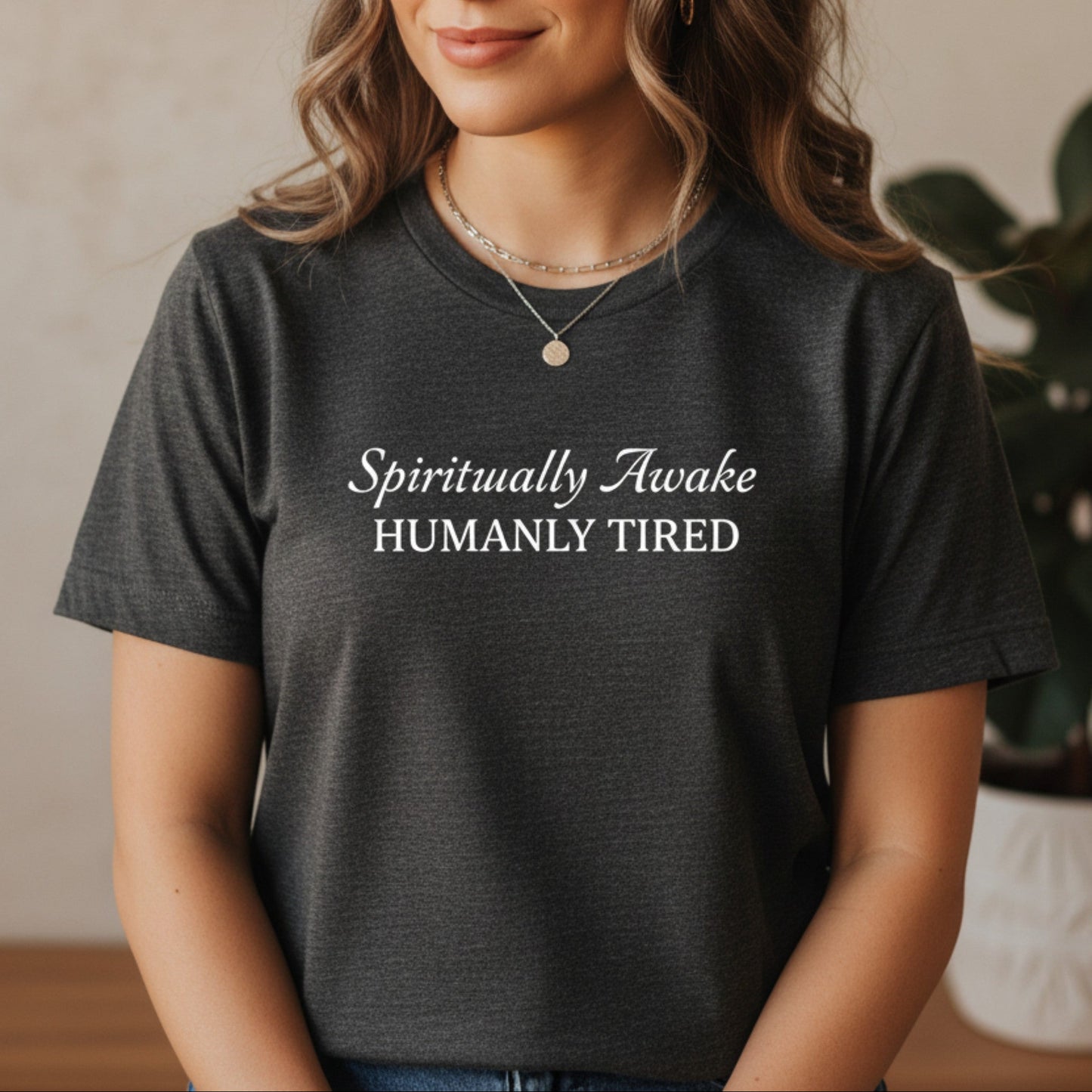 Dark gray heather Spiritually Awake Humanly Tired t-shirt with white script and caps print — cozy everyday spiritual tee for the woman who meditates every morning and still needs three coffees