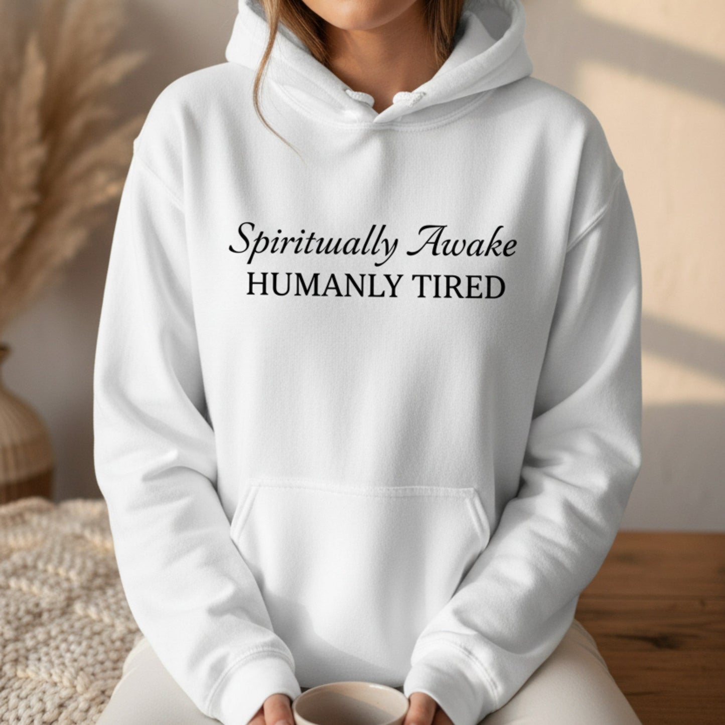 White Spiritually Awake Humanly Tired pullover hoodie with black script and serif print — clean minimal funny spiritual gift for the woman who is fully awakened and absolutely ready for a nap