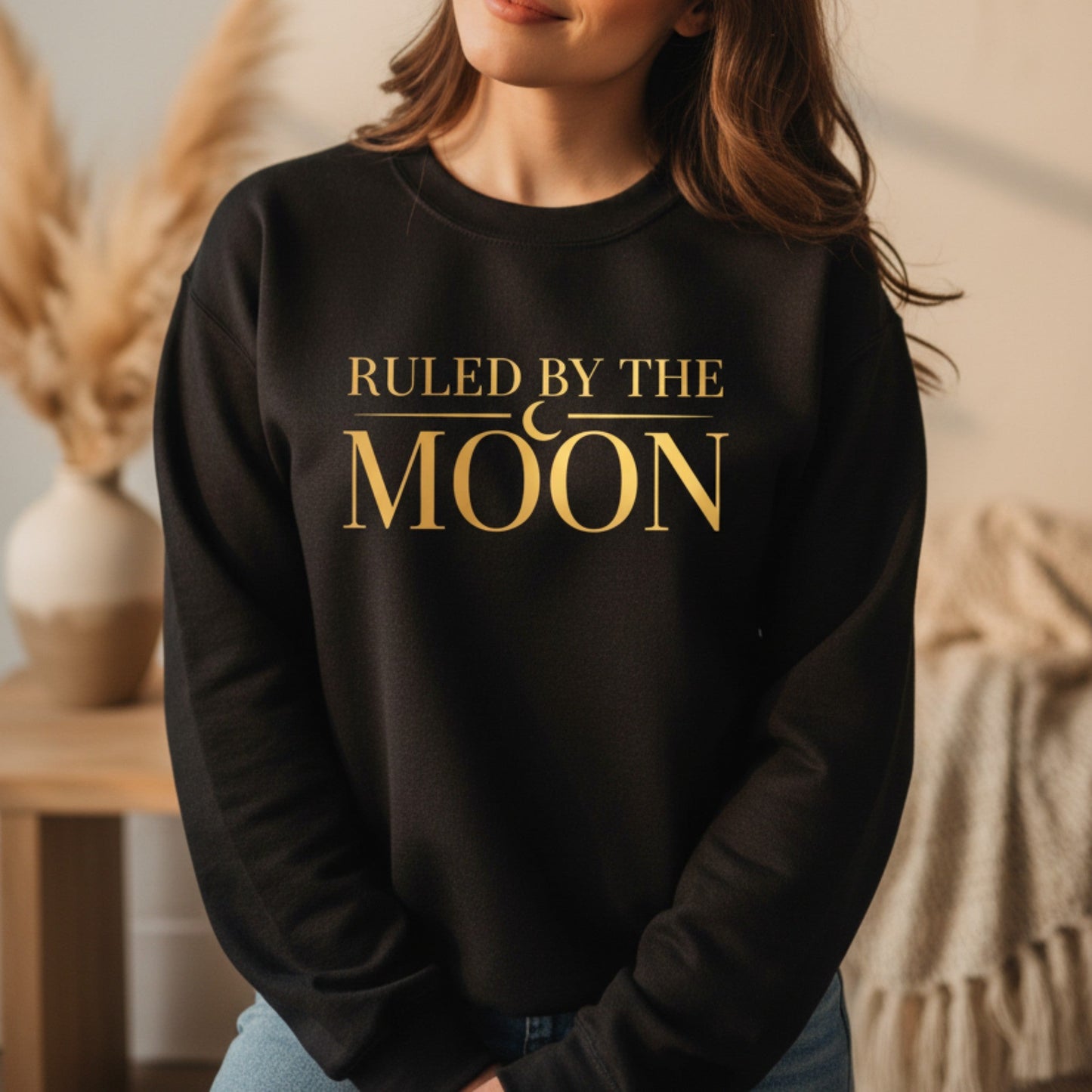 Black oversized crewneck with gold moon phase typography — astrology lover gift for women who live by celestial energy