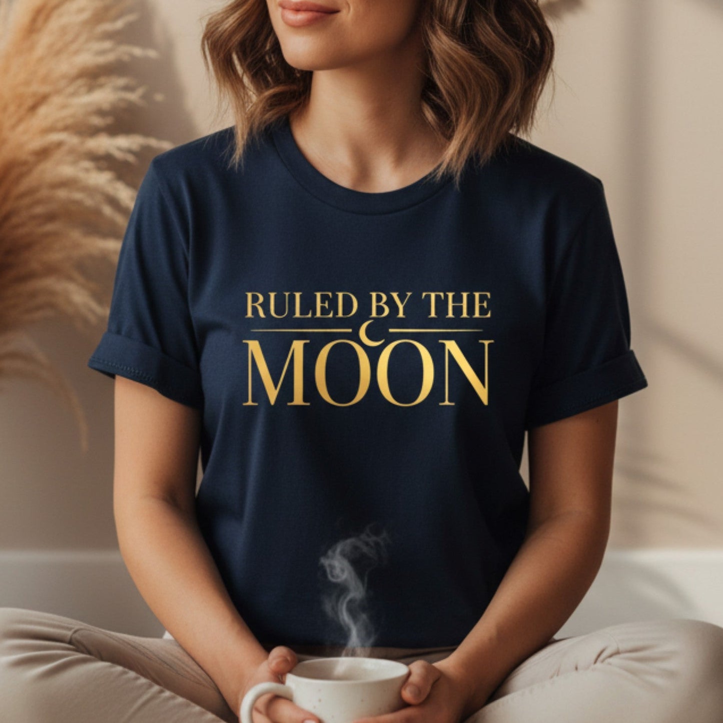 Navy blue ruled by the moon shirt with gold lunar typography — astrology gift tee for women who set intentions by the new moon