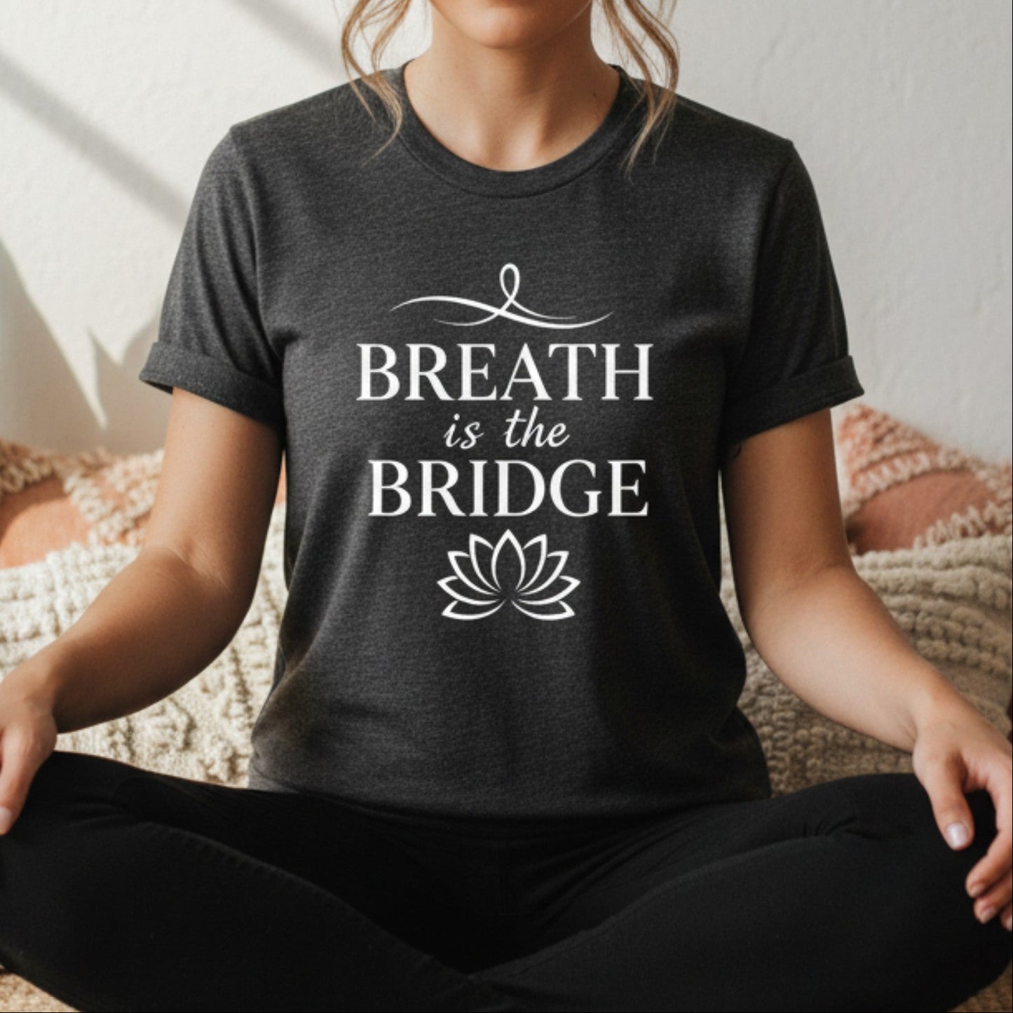 Dark gray heather Breath Is The Bridge t-shirt with white serif and script print — cozy everyday yoga tee for the woman who lives with intention on and off the mat