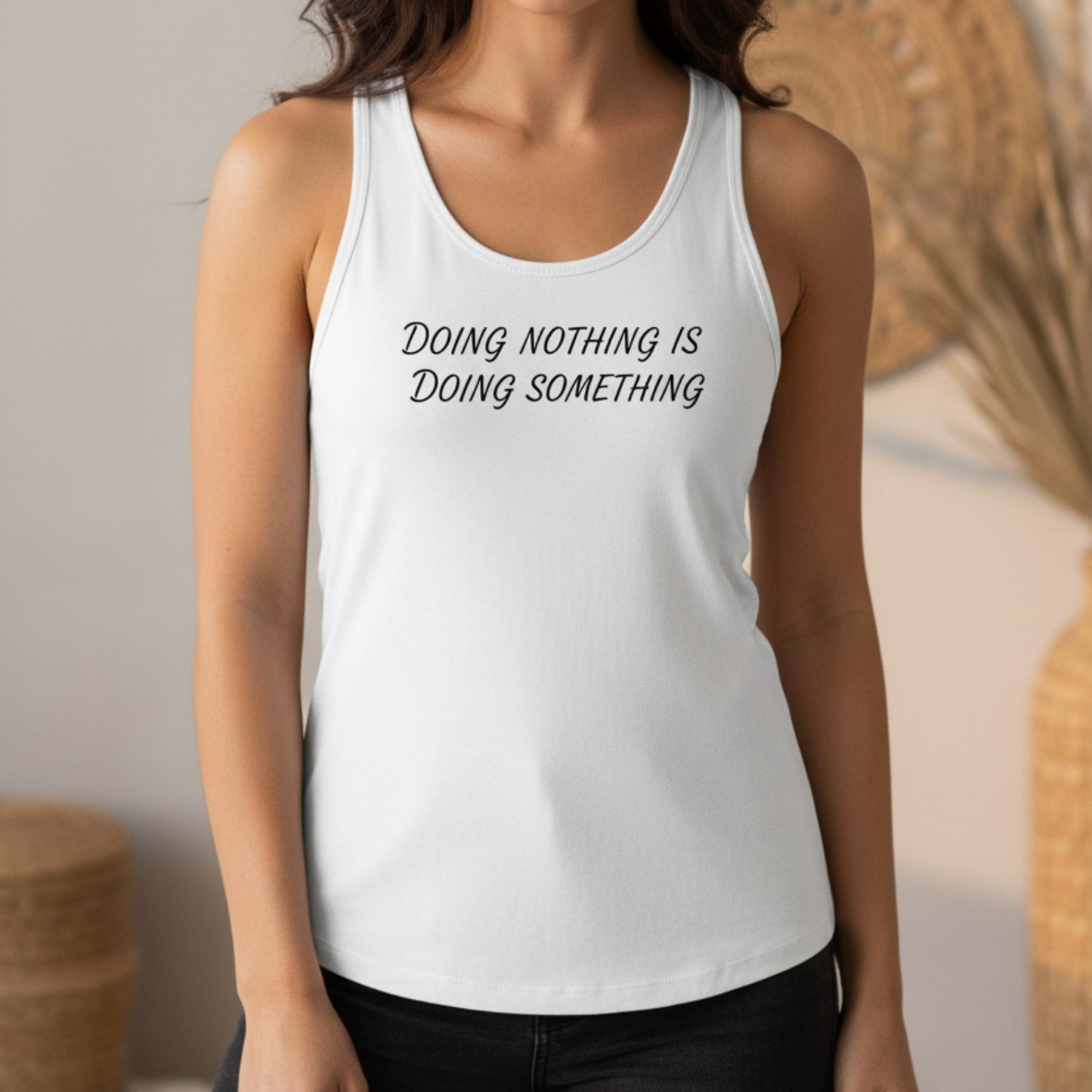 White women's racerback tank with self-care message — Doing Nothing Is Doing Something black HTV print, fitted hip-length silhouette