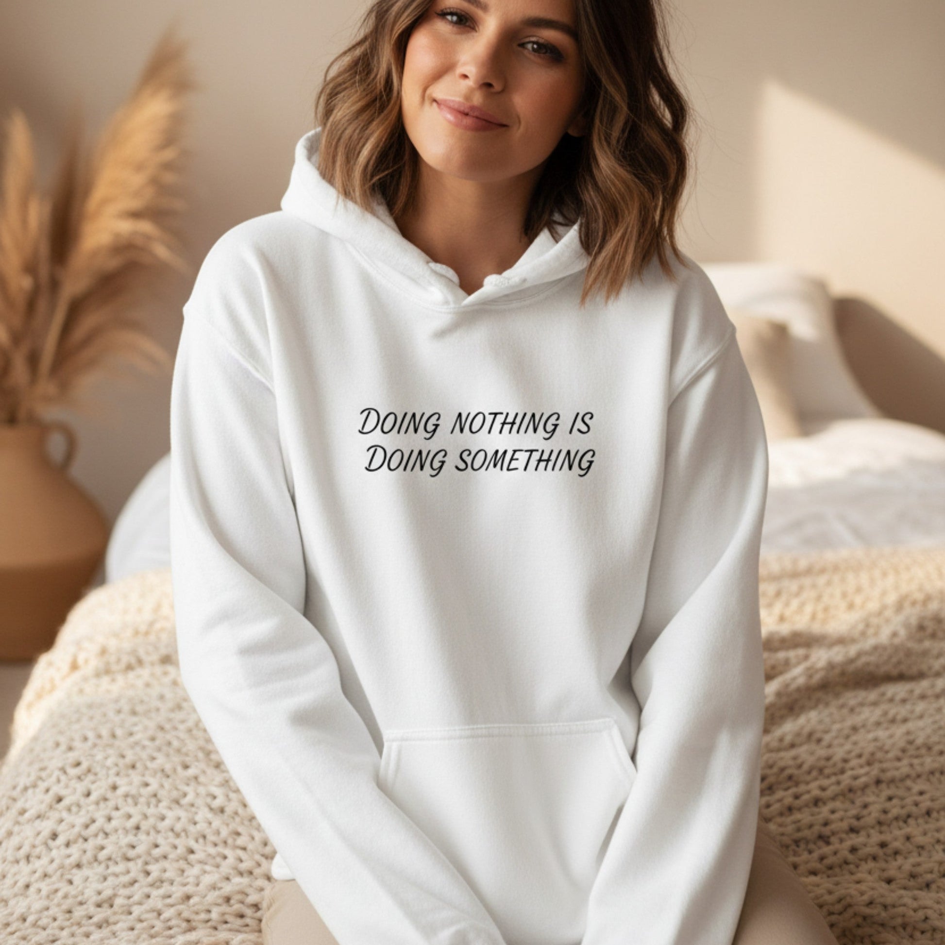 "Doing Nothing Is Doing Something" women's graphic hoodie in dark heather grey — funny self-care gift for her