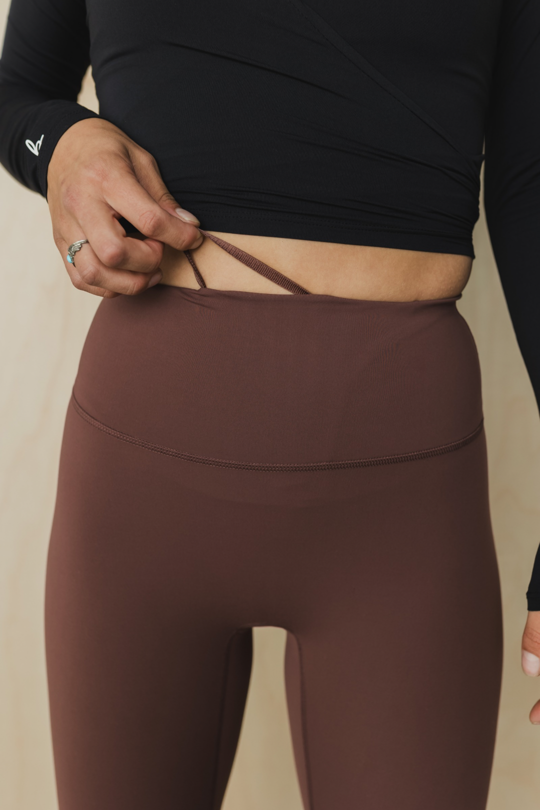 zoomed in front view of a woman wearing running pant in russet for running and casual athletic wear