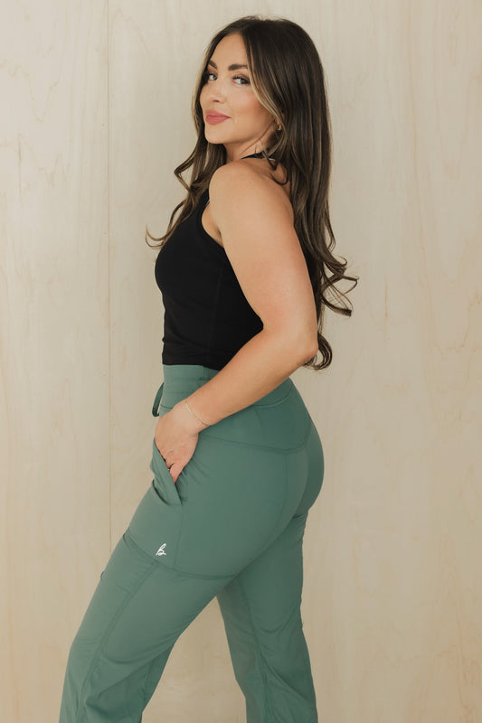 pocket view of a woman wearing rocky Mountain pant in spruce green for hiking and nature-inspired activewear