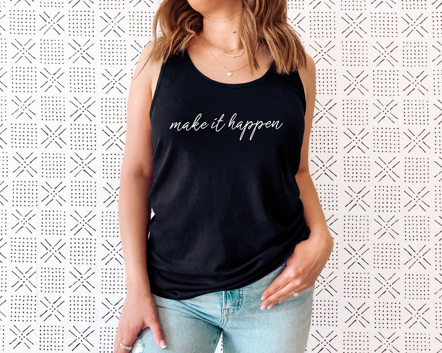 Women's empowerment racerback tank with bold "Make It Happen" affirmation print in black