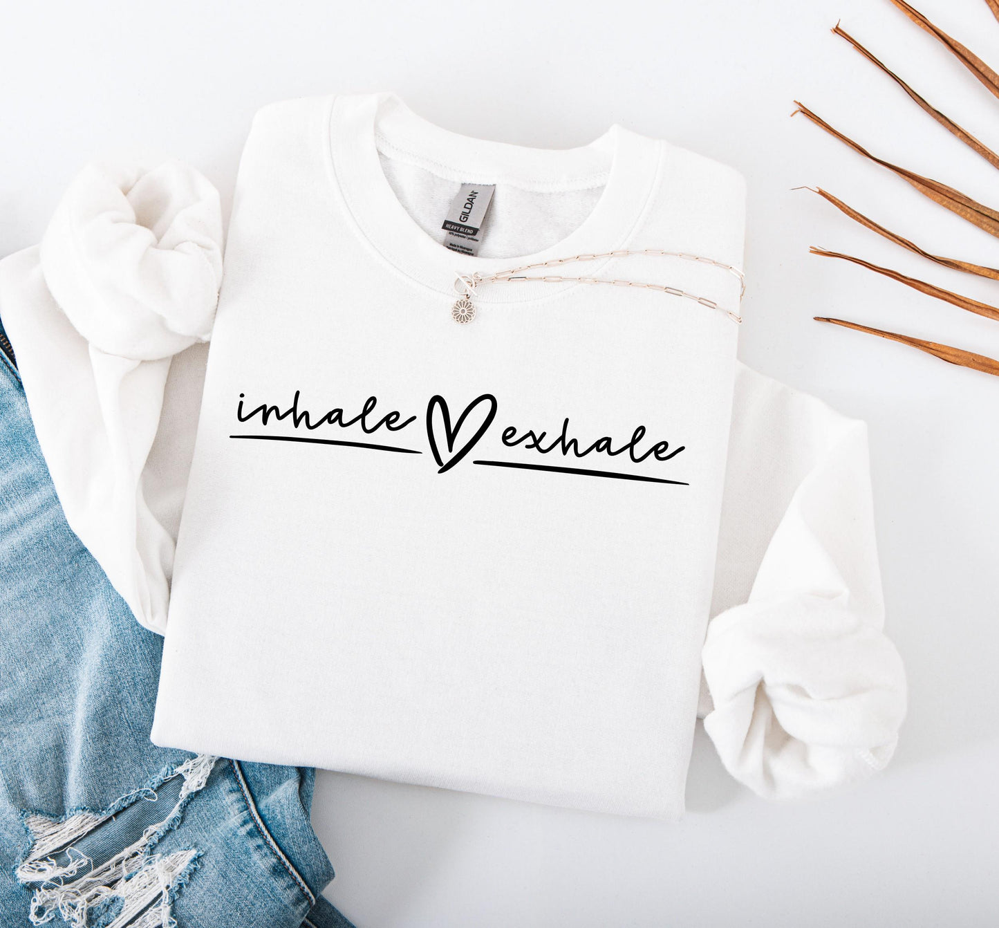 Inhale Exhale sweatshirt close-up showing soft fabric and calming print detail in white