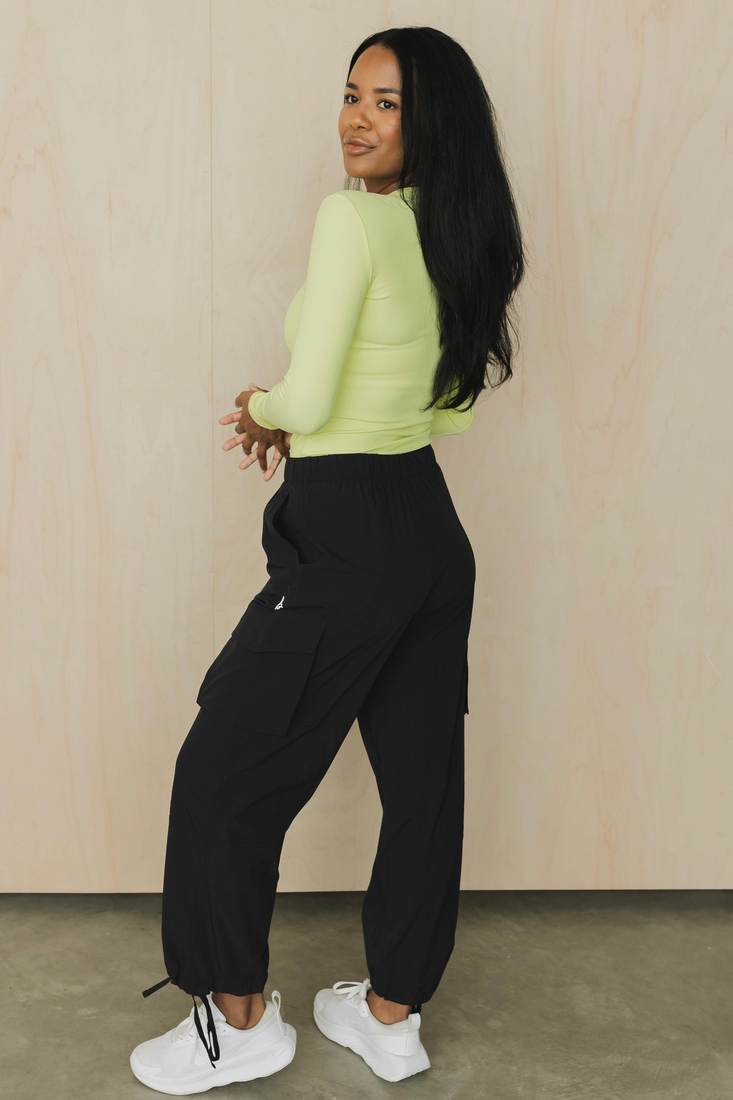 side back view of a woman wearing cargo pant in black for streetwear and versatile everyday styling