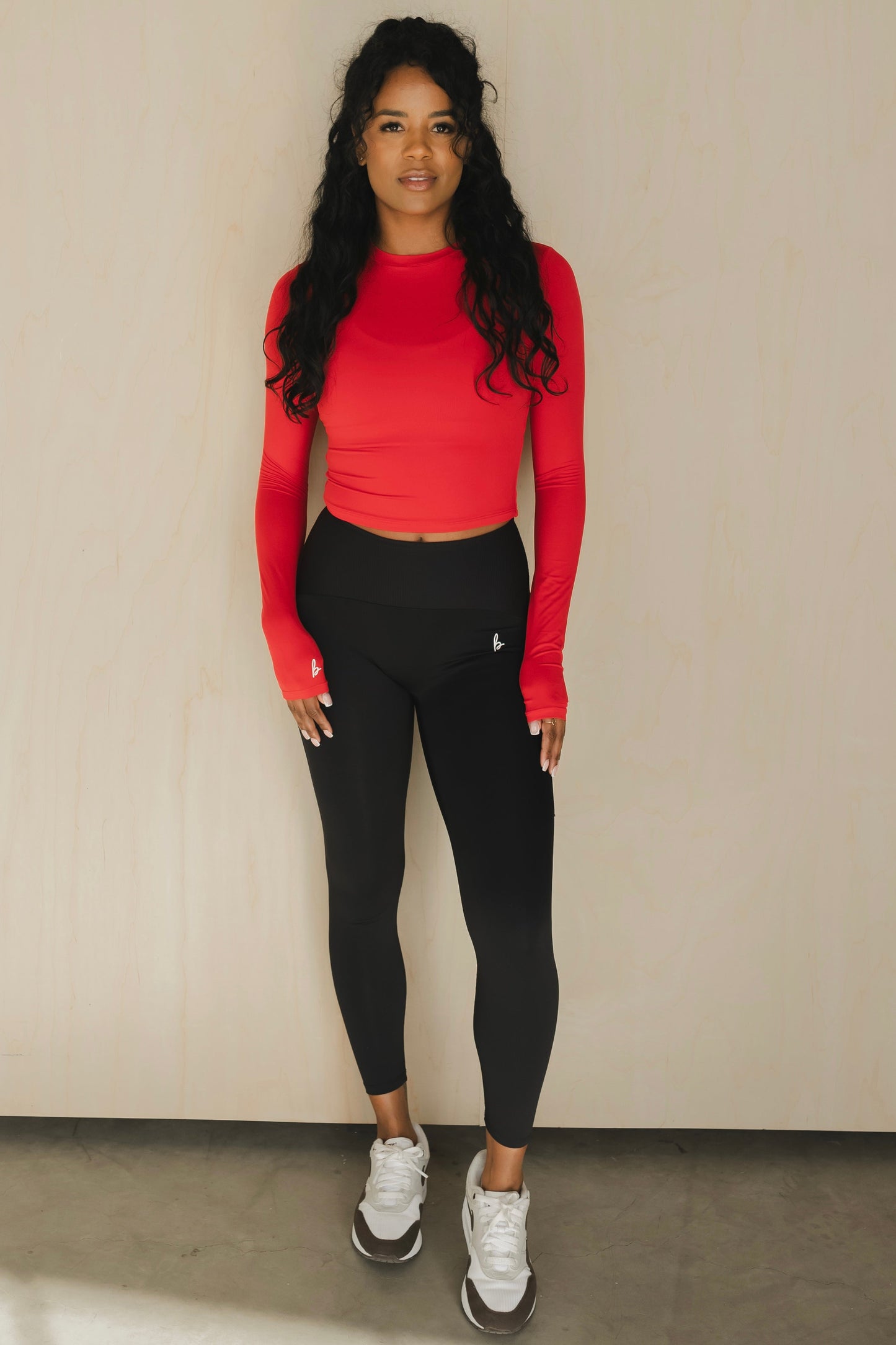 front view of a woman wearing 25 inch elevation leggings in black for the gym and everyday activewear
