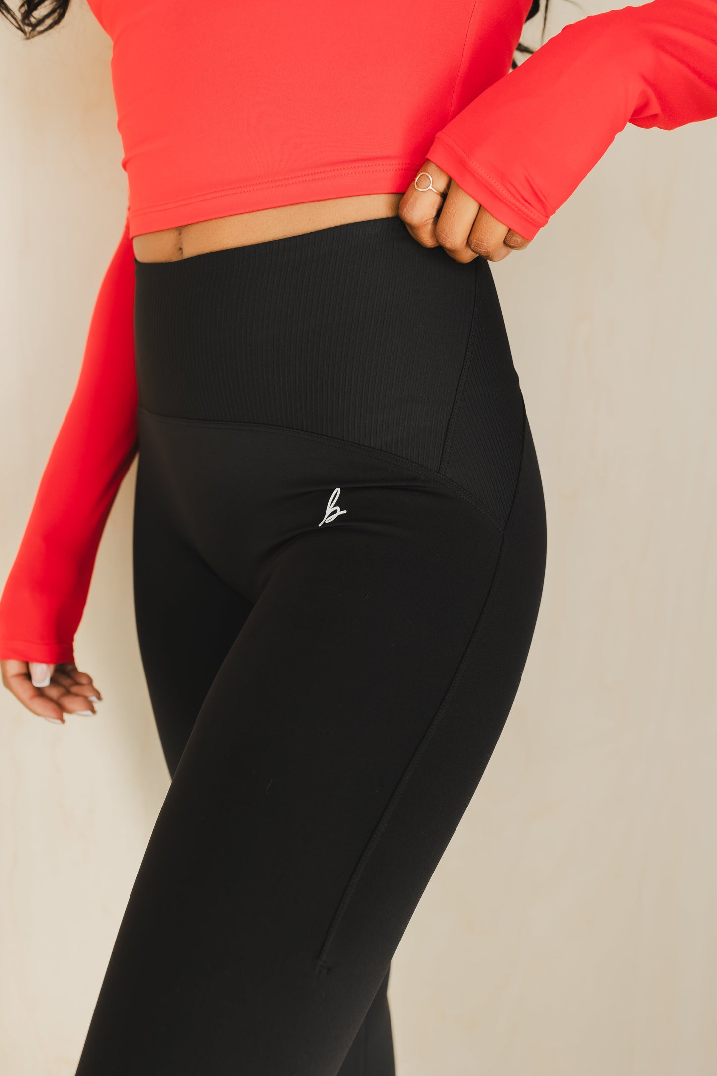 side view of a woman wearing 25 inch elevation leggings in black for the gym and everyday activewear