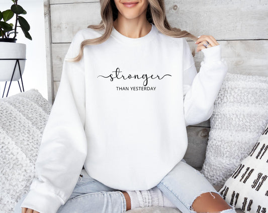Empowering "Stronger Than Yesterday" sweatshirt for resilient and driven women in white