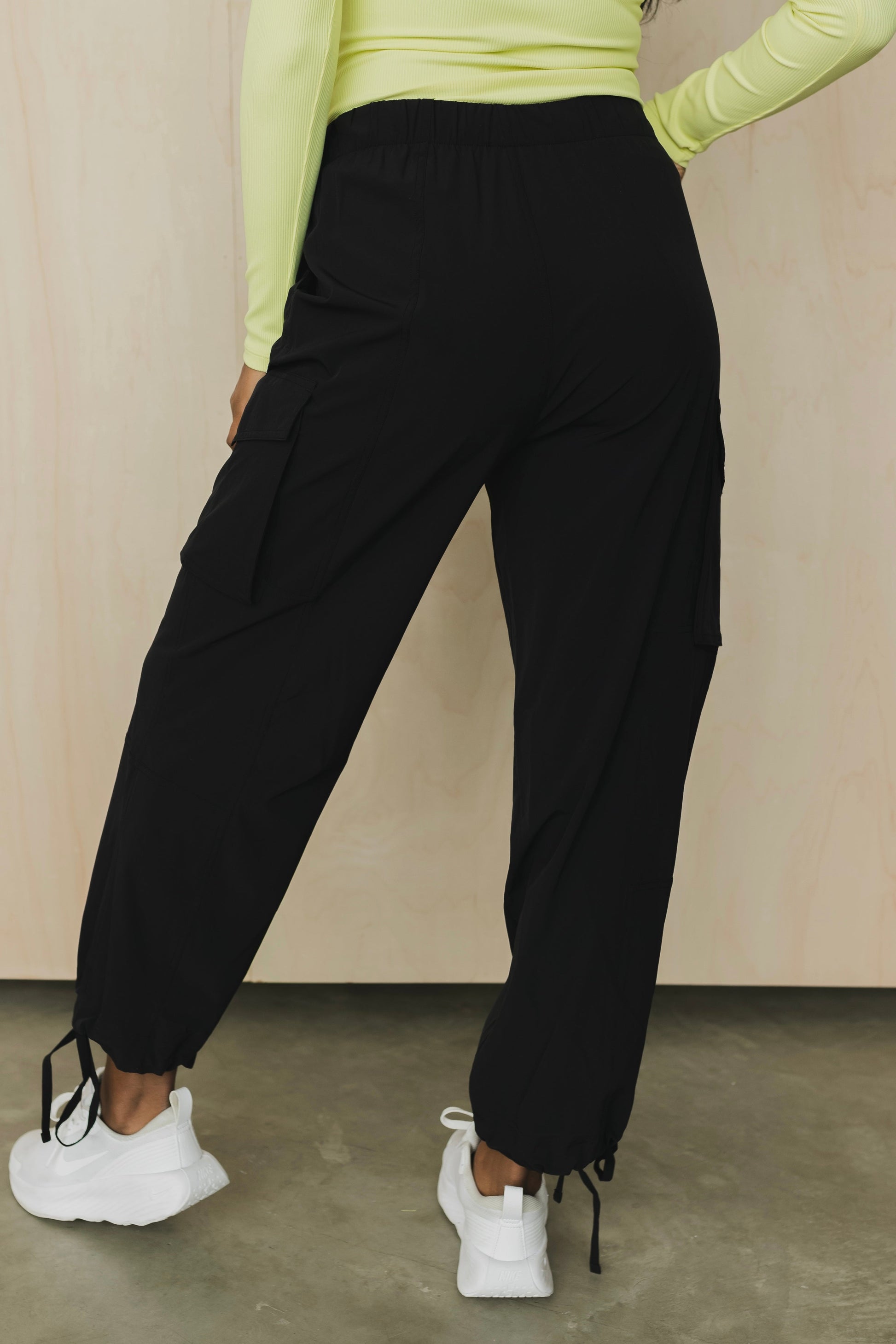 back view of a woman wearing cargo pant in black for streetwear and versatile everyday styling