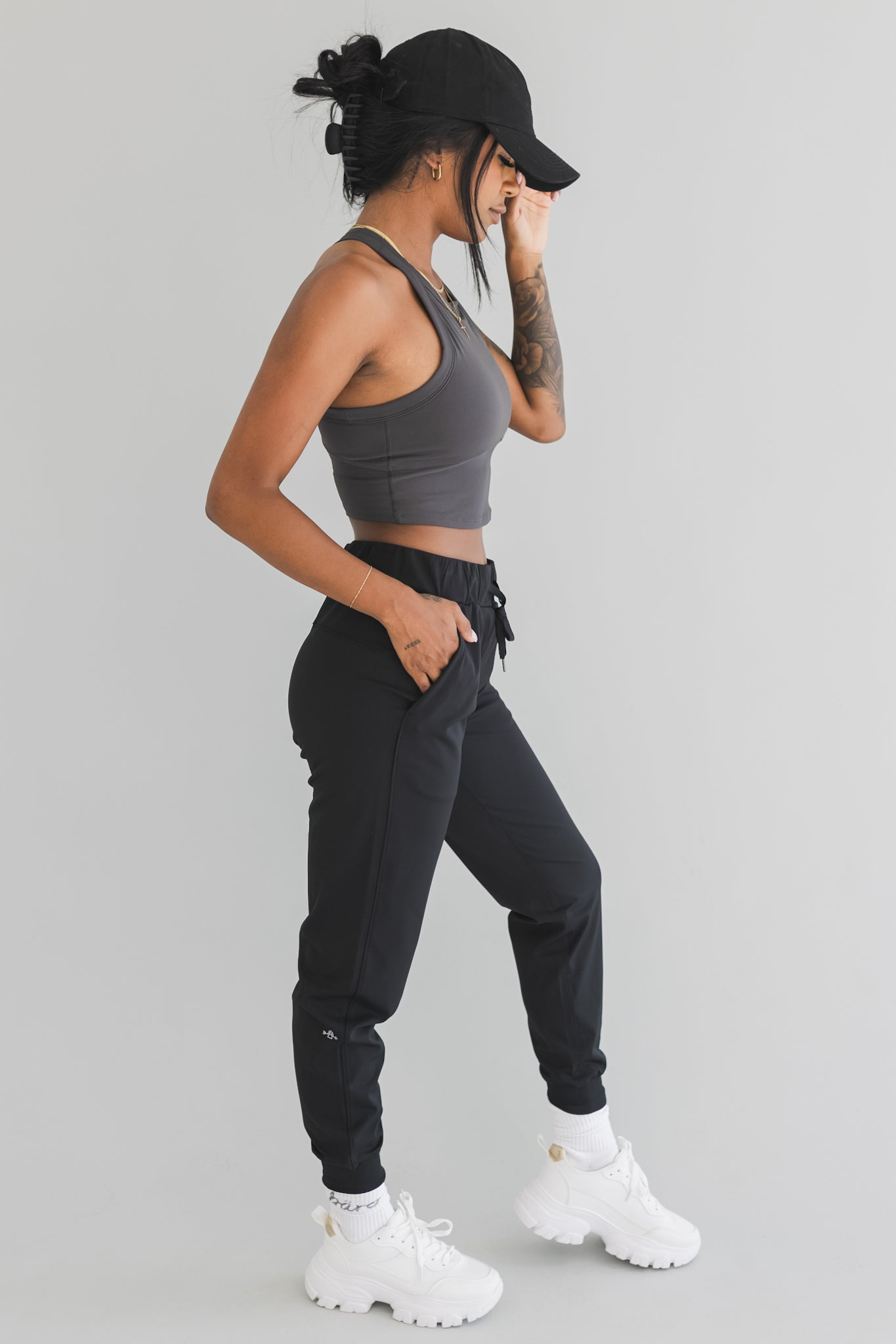 side view of a woman wearing cuffed ankle jogger in black camo for streetwear and everyday wear