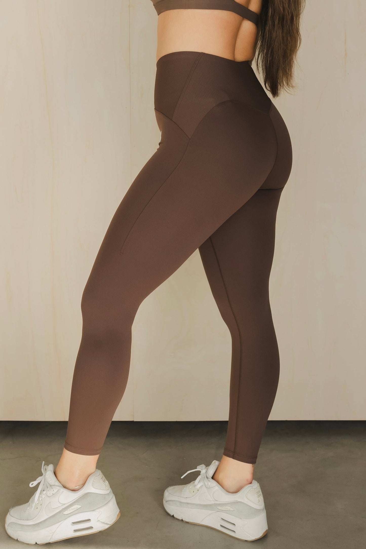 zoomed out side view of a woman wearing 25 inch elevation leggings in french press for yoga and studio workouts