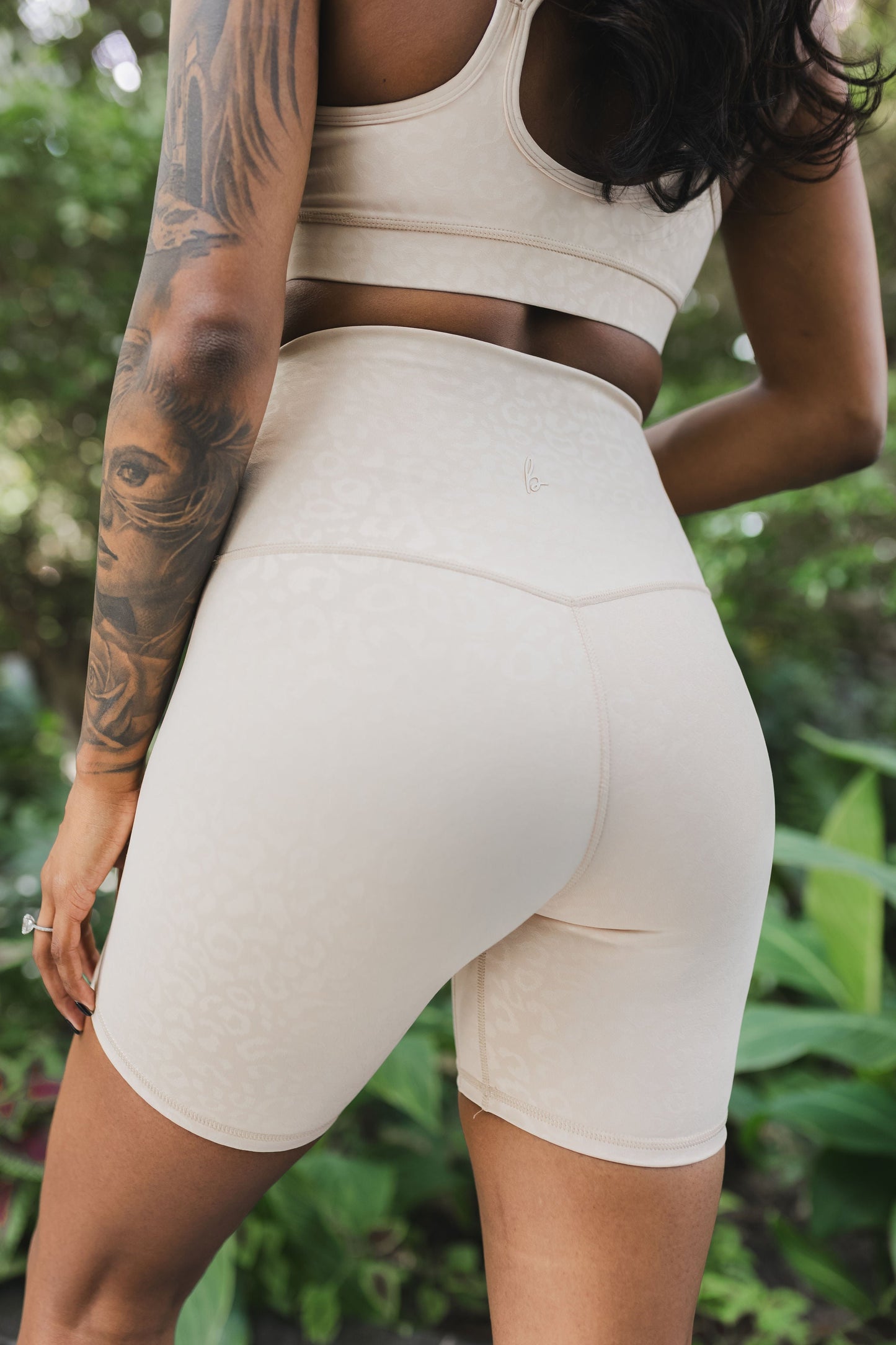 back view of woman wearing barely there 6 inch shorts in ivory leopard print for yoga and activewear