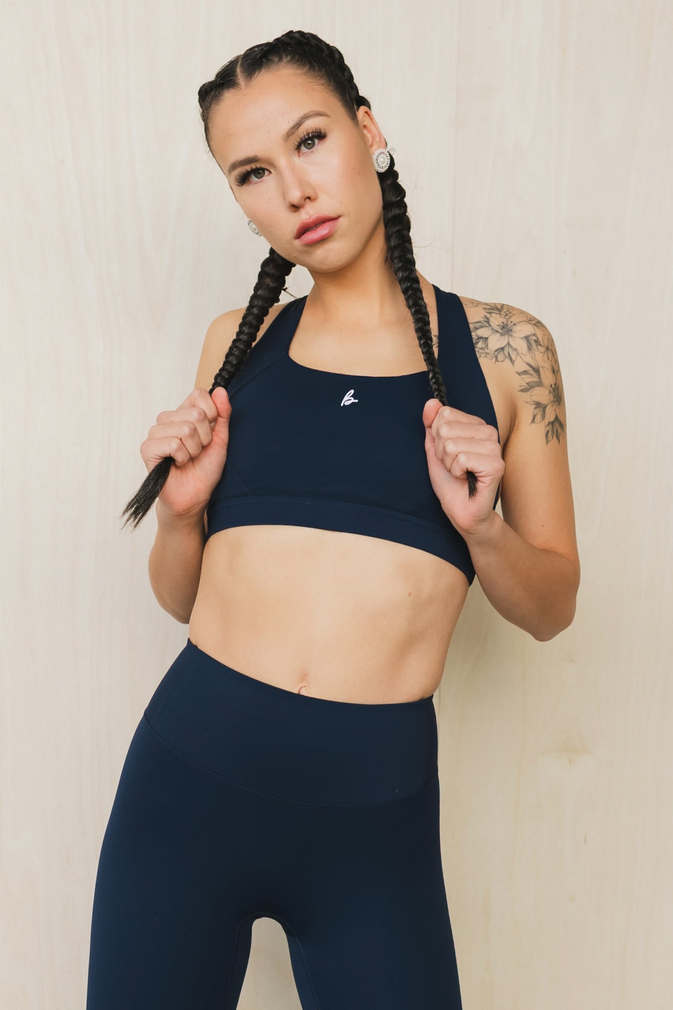 front view of a woman wearing a Fight or Flight high-support sports bra in midnight blue for yoga and fitness