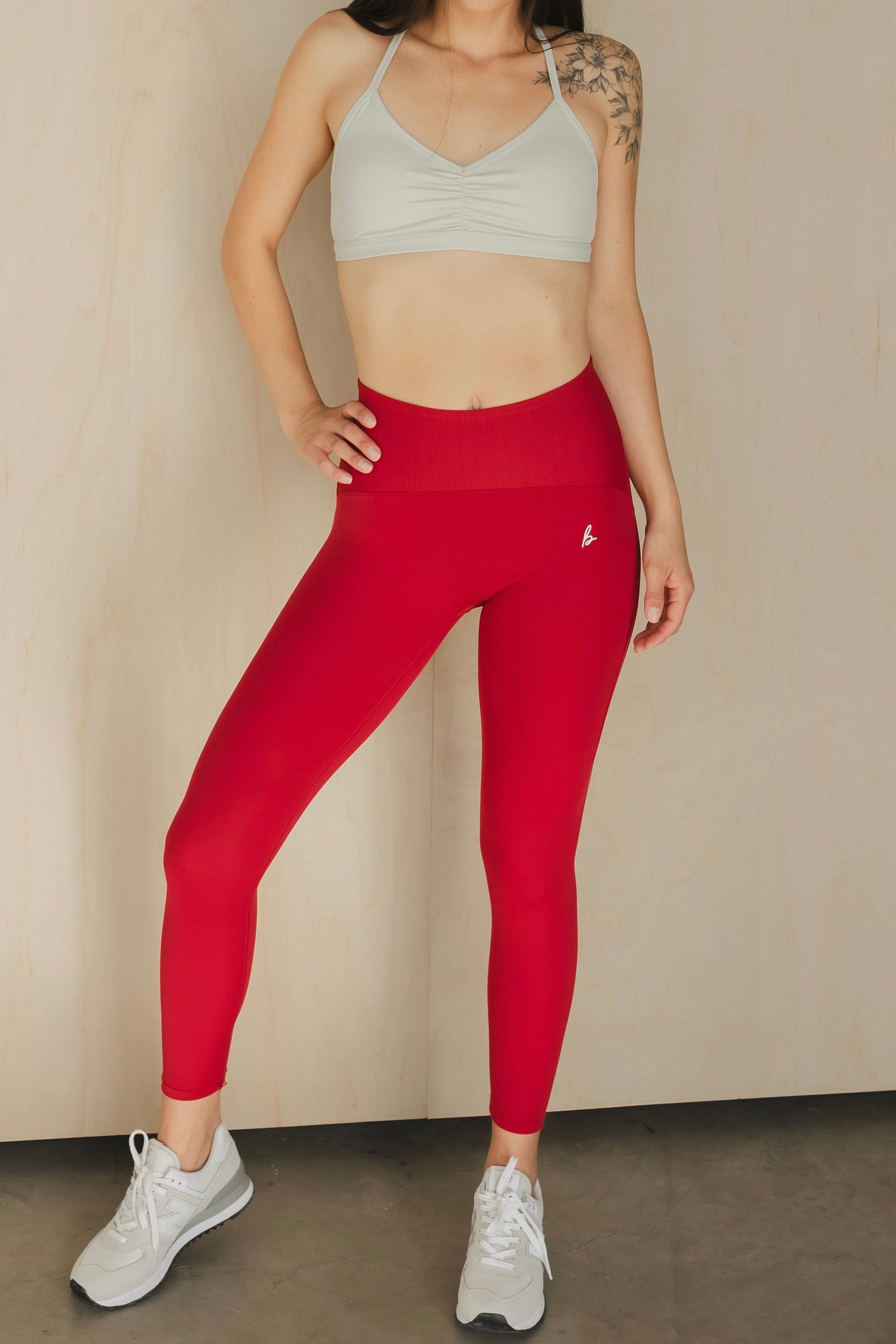 front view of a woman wearing 25 inch elevation leggings in royal crimson for pilates and high performance training