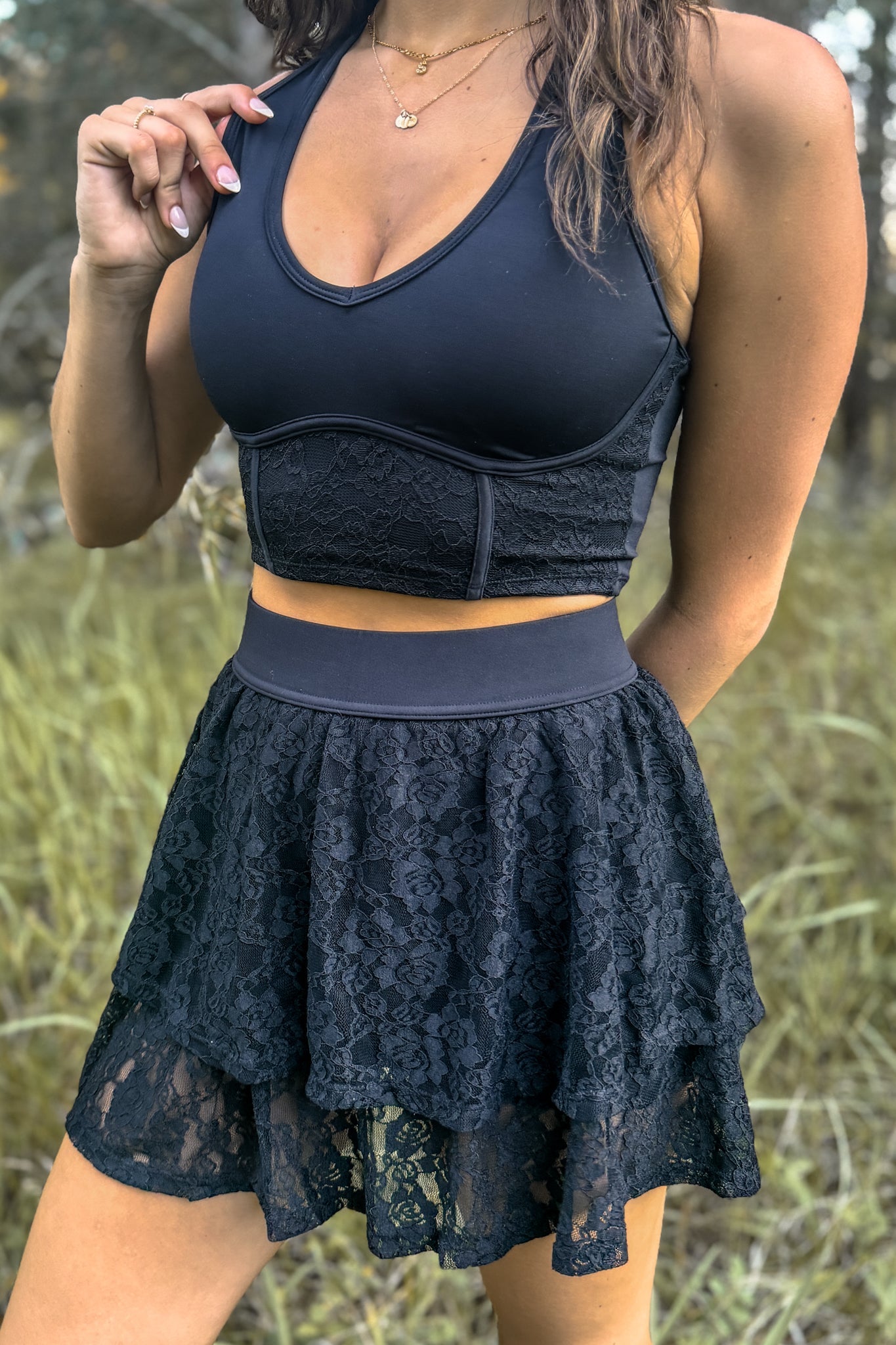 close up front view of woman wearing a stampede lace active skirt with built-in shorts in black for festivals and activewear