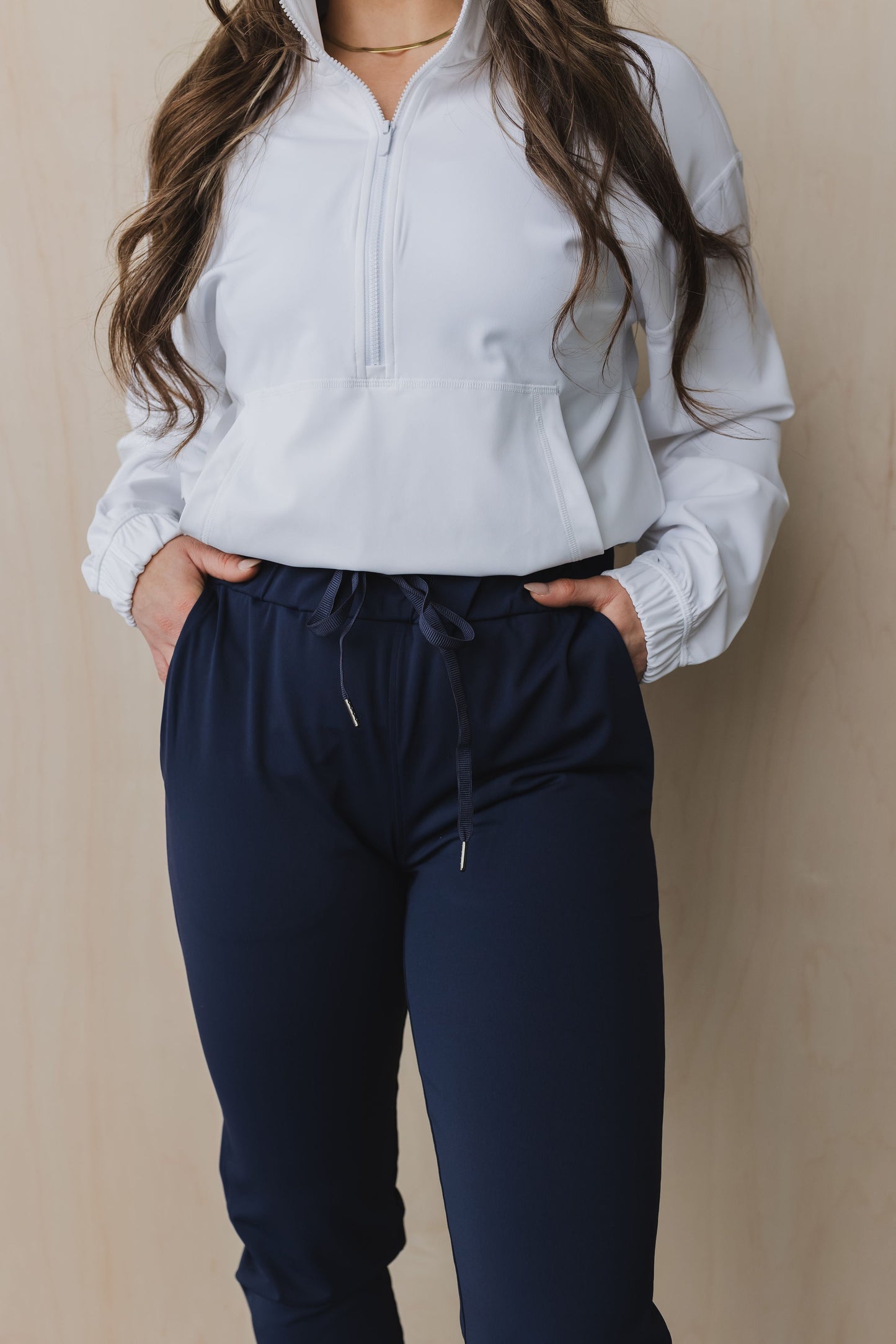 close up front view of a woman wearing cuffed ankle jogger in indigo for workouts and casual wear