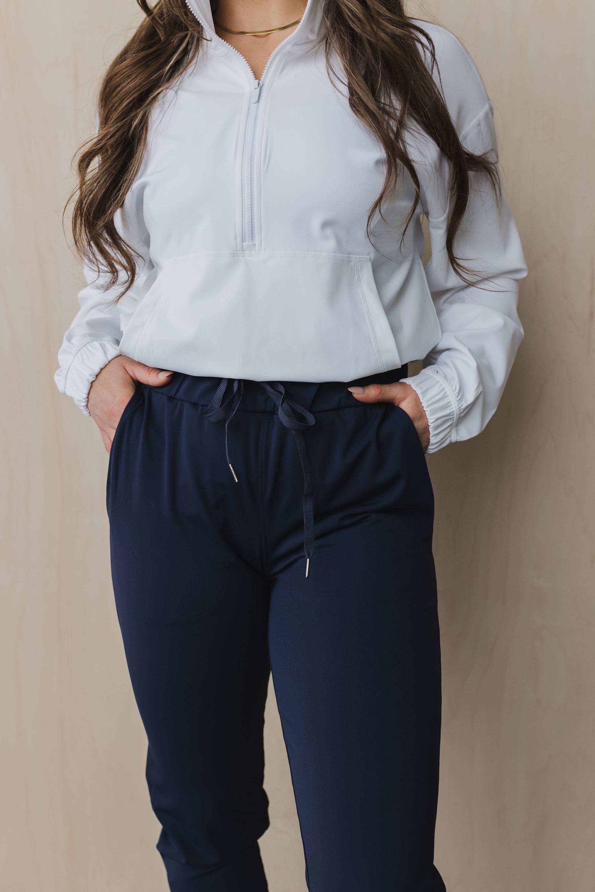 close up front view of a woman wearing cuffed ankle jogger in indigo for workouts and casual wear