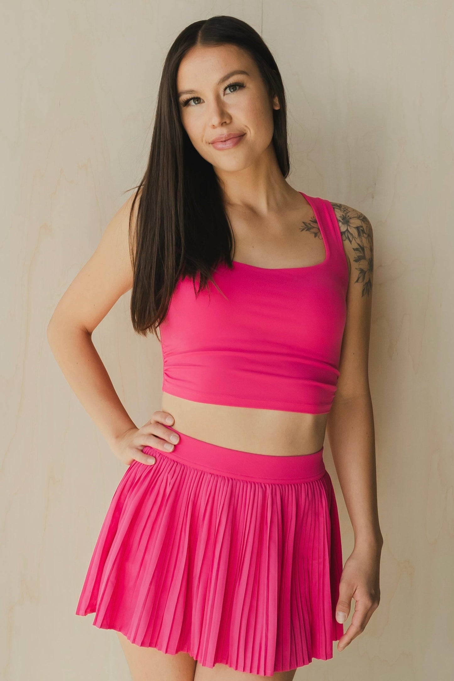 font view of a woman wearing a sweetheart tank top in passion pink for yoga and activewear