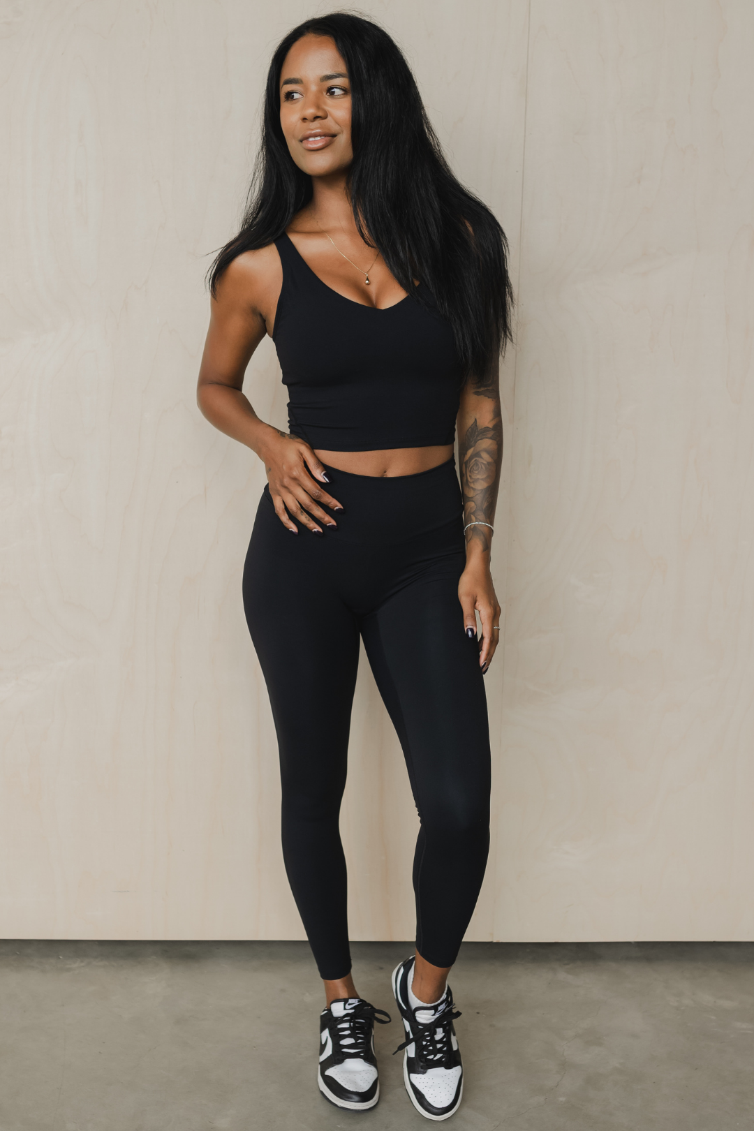 front view of a woman wearing 25 inch barely there leggings in black for loungewear and athletic wear