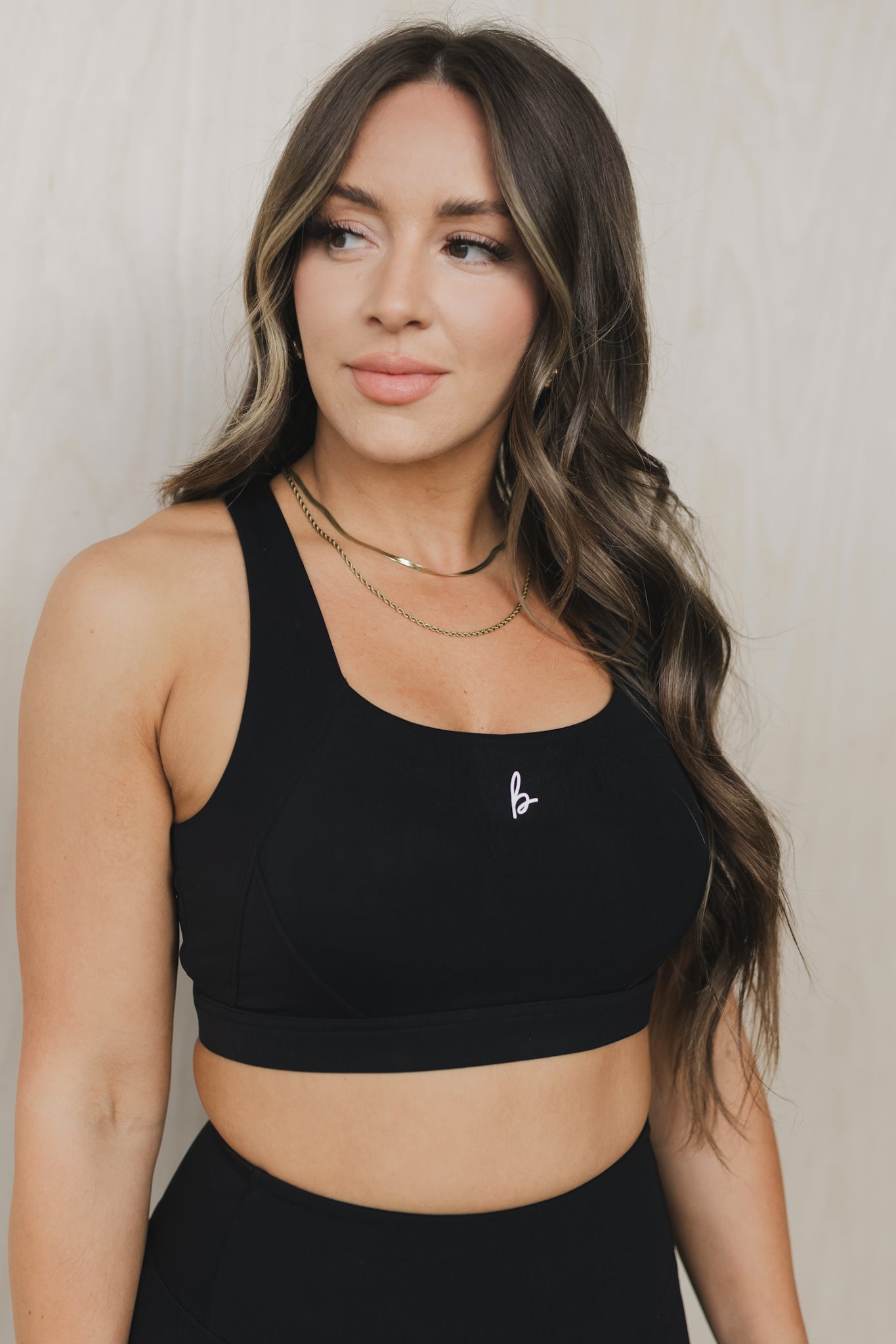 font view of a woman wearing a Fight or Flight high-support sports bra in black for yoga and fitness