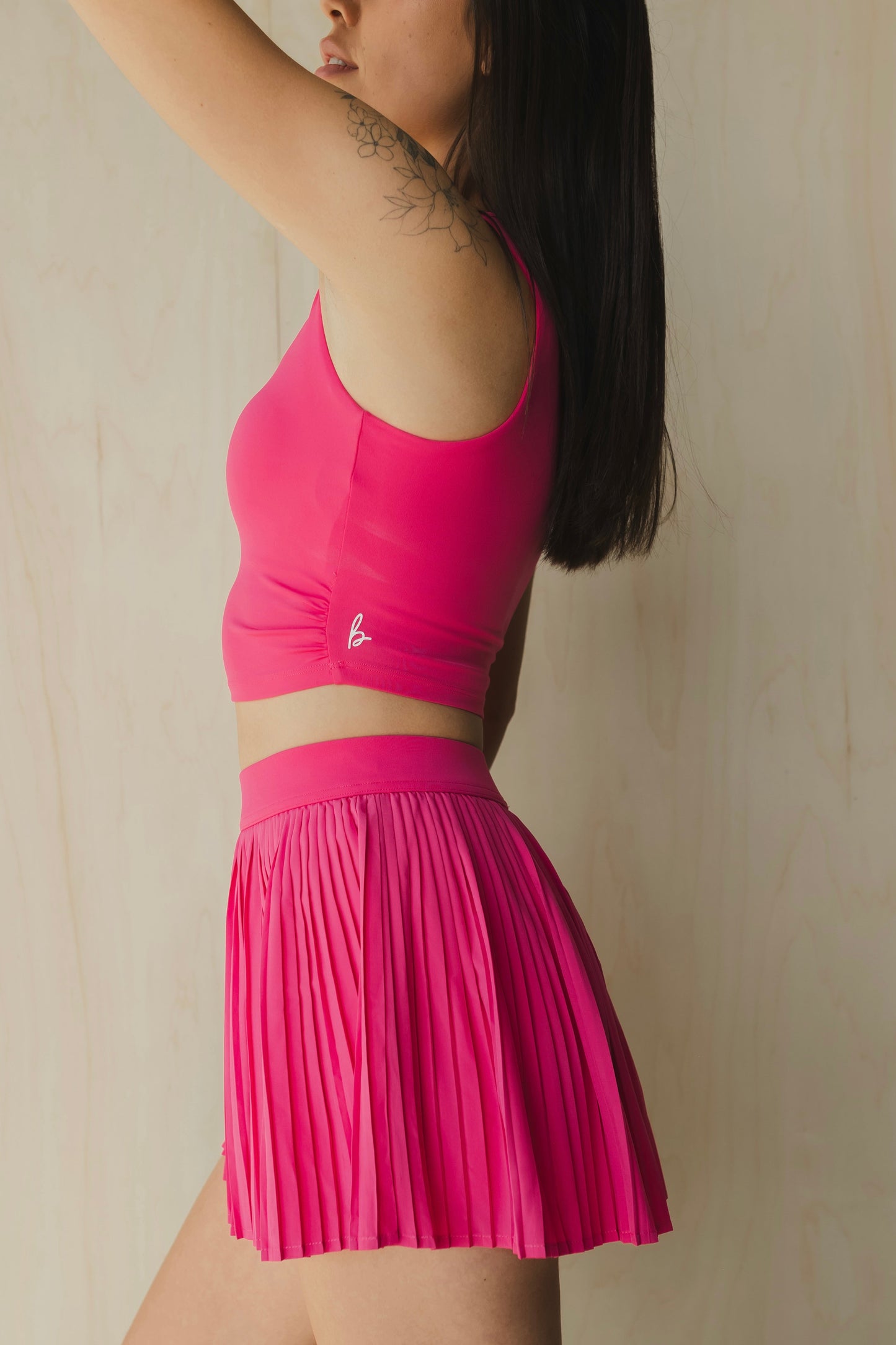 side view of a woman wearing a sweetheart tank top in passion pink for yoga and activewear