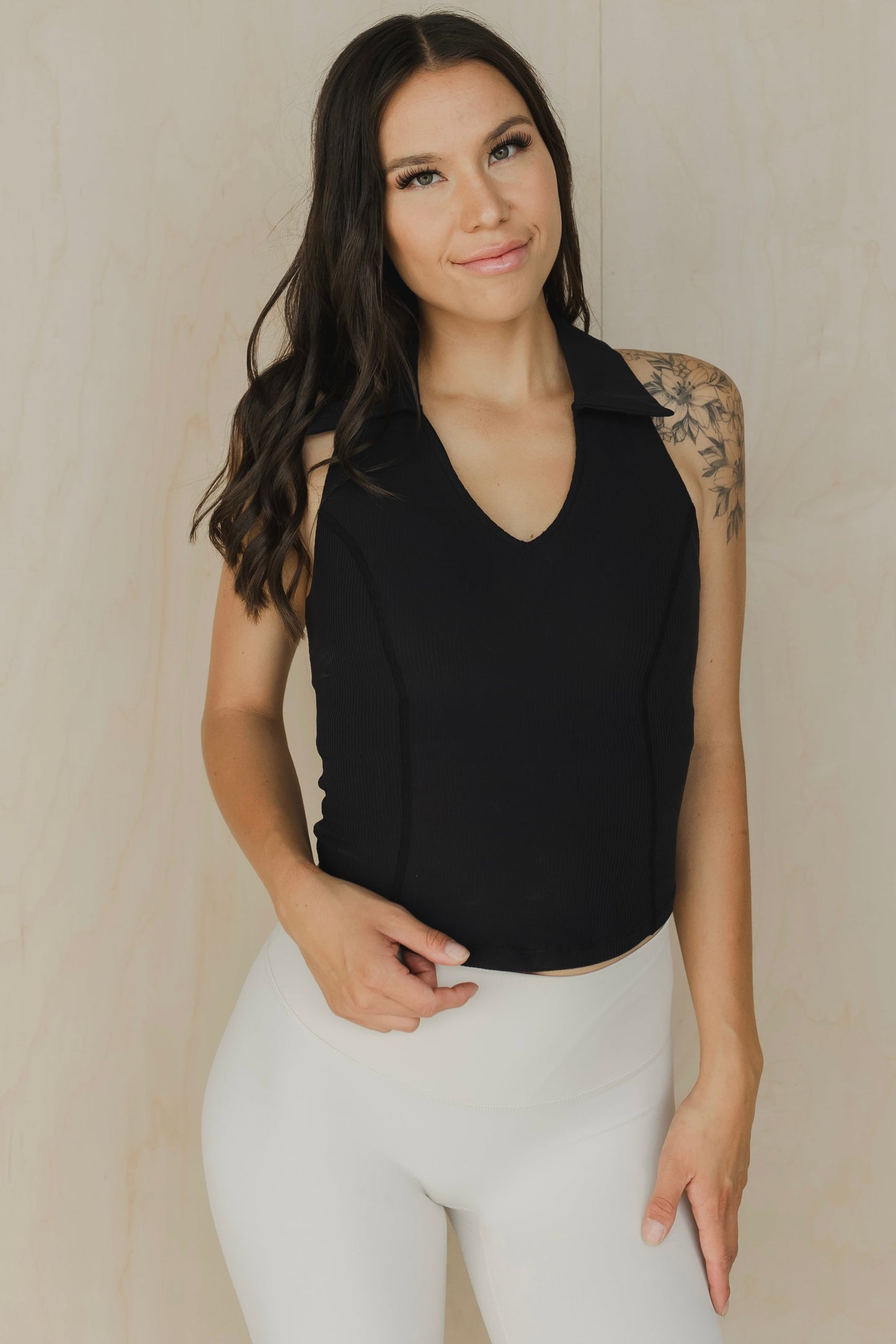 front view of a woman wearing a Ace tank top in black for golf yoga and activewear
