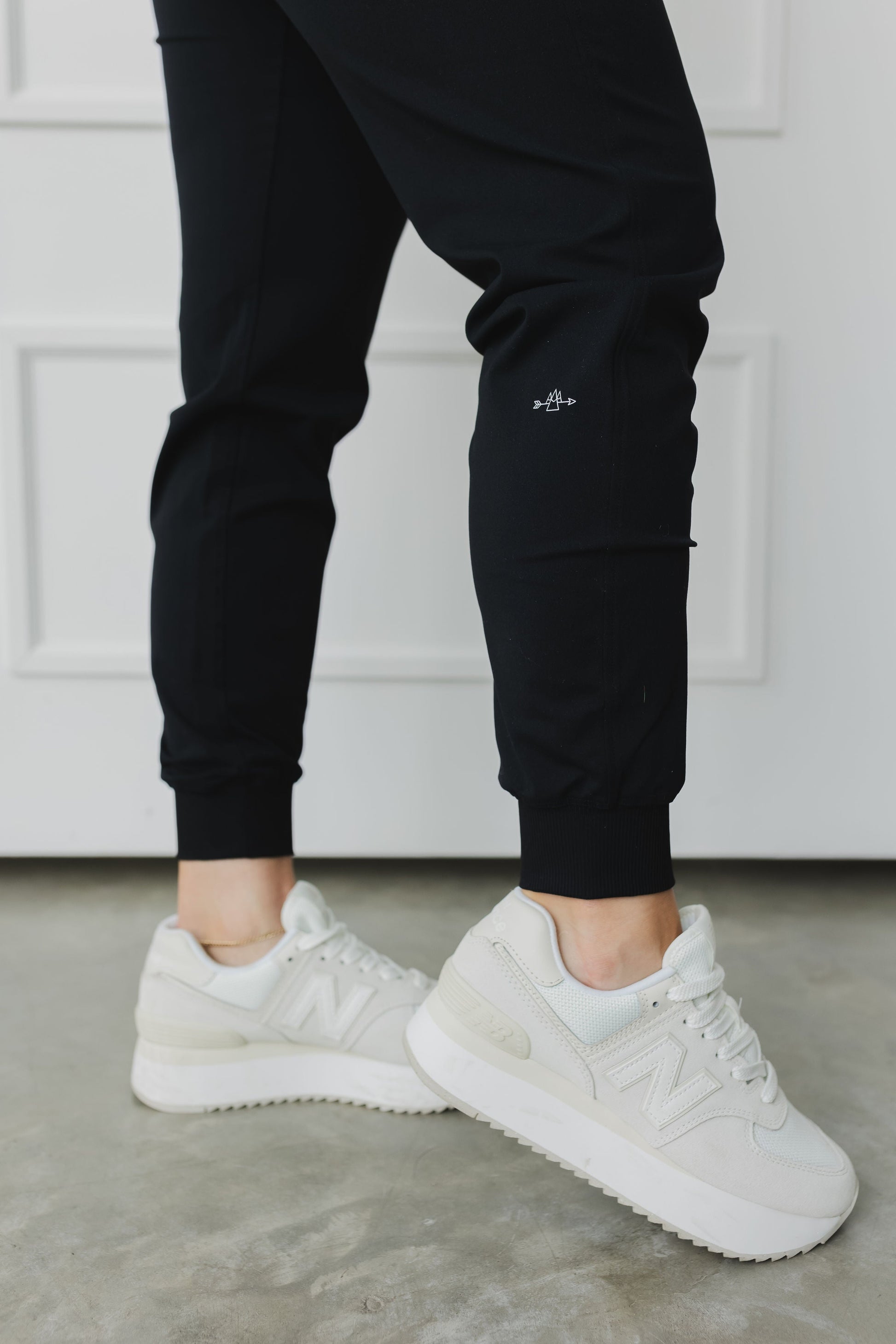 ankle view of a woman wearing cuffed ankle jogger in black for loungewear and casual athleisure 
