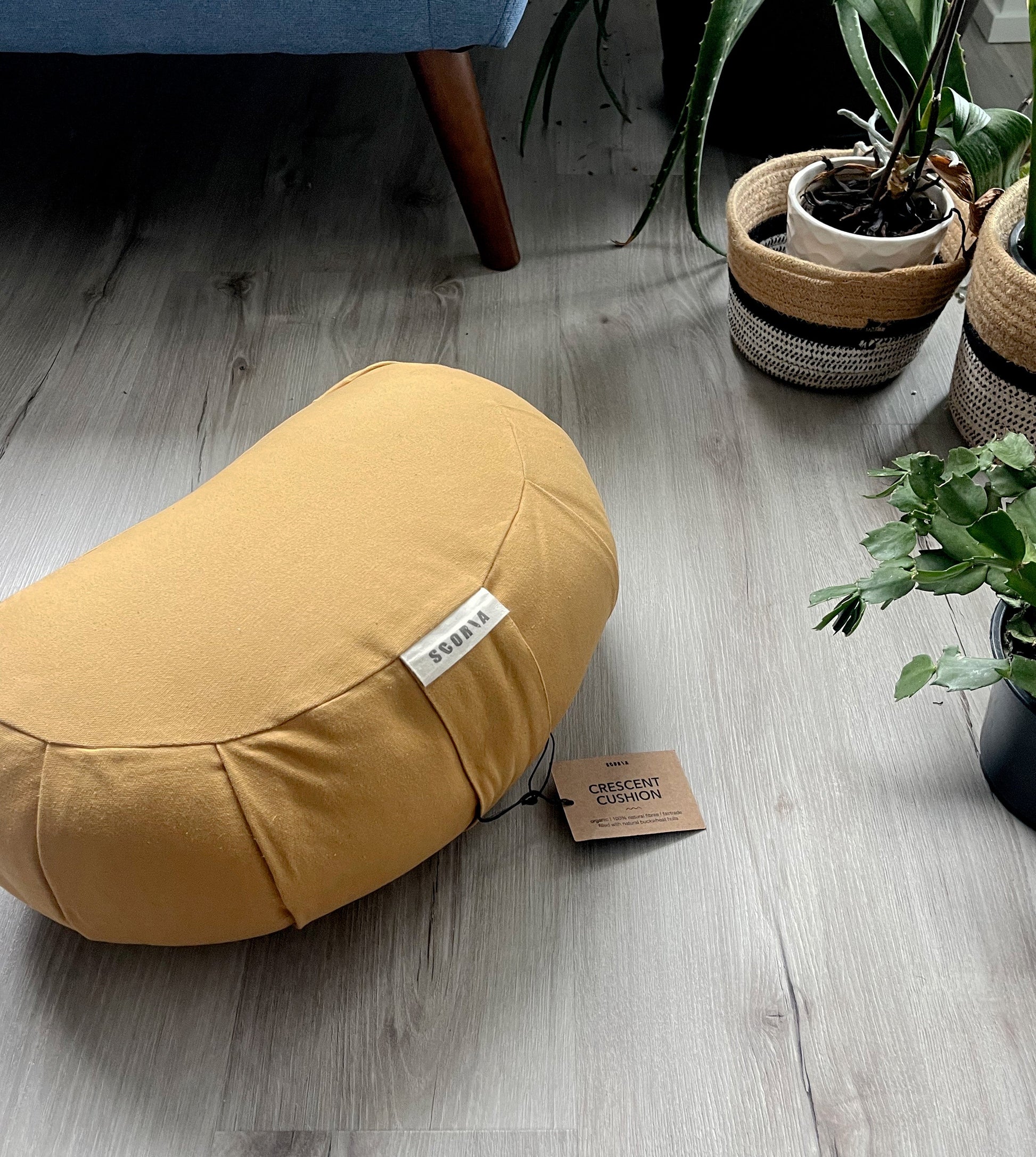 gold meditation / yoga pillow on a wood floor