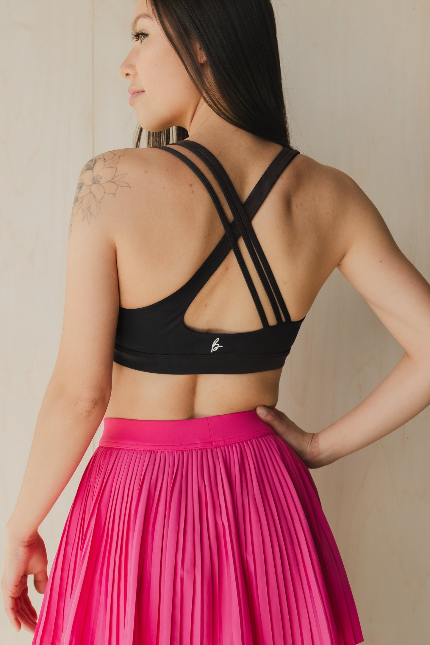 back view of a woman wearing S.F. V3 sports bra in lack for gym and high impact workouts