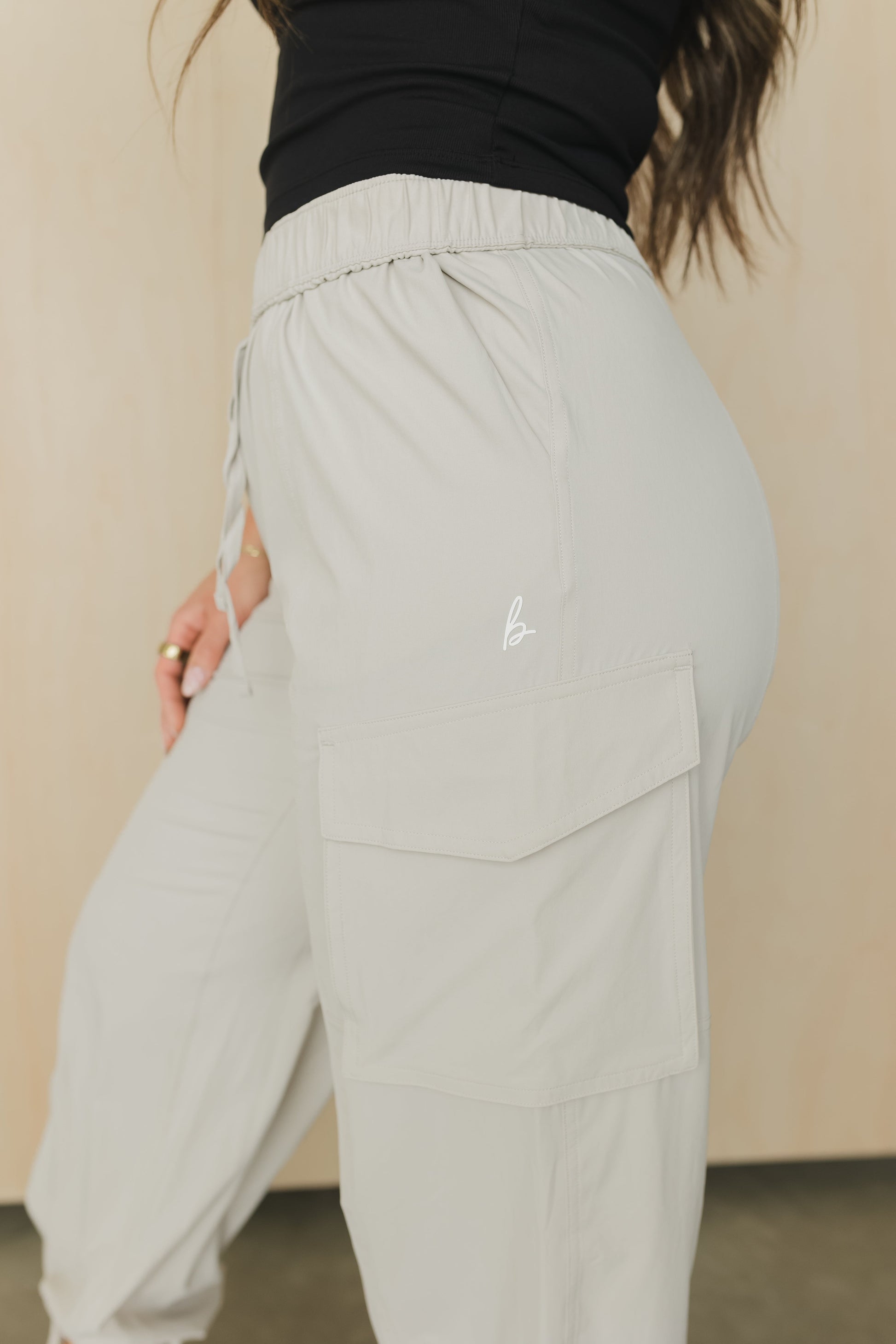 side view of a woman wearing cargo pant in birch bark for outdoor wear and casual athleisure