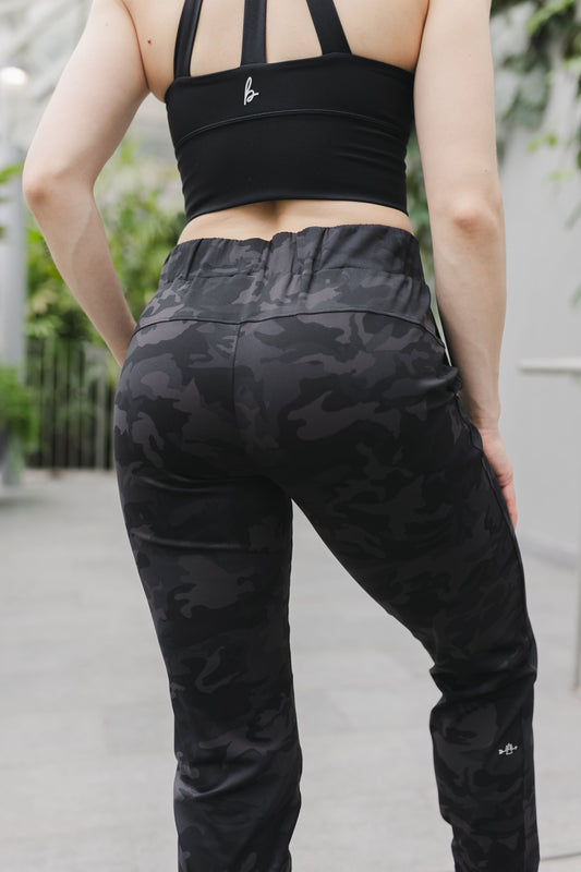 close up back view of a woman wearing cuffed ankle jogger in black camo for streetwear and everyday wear
