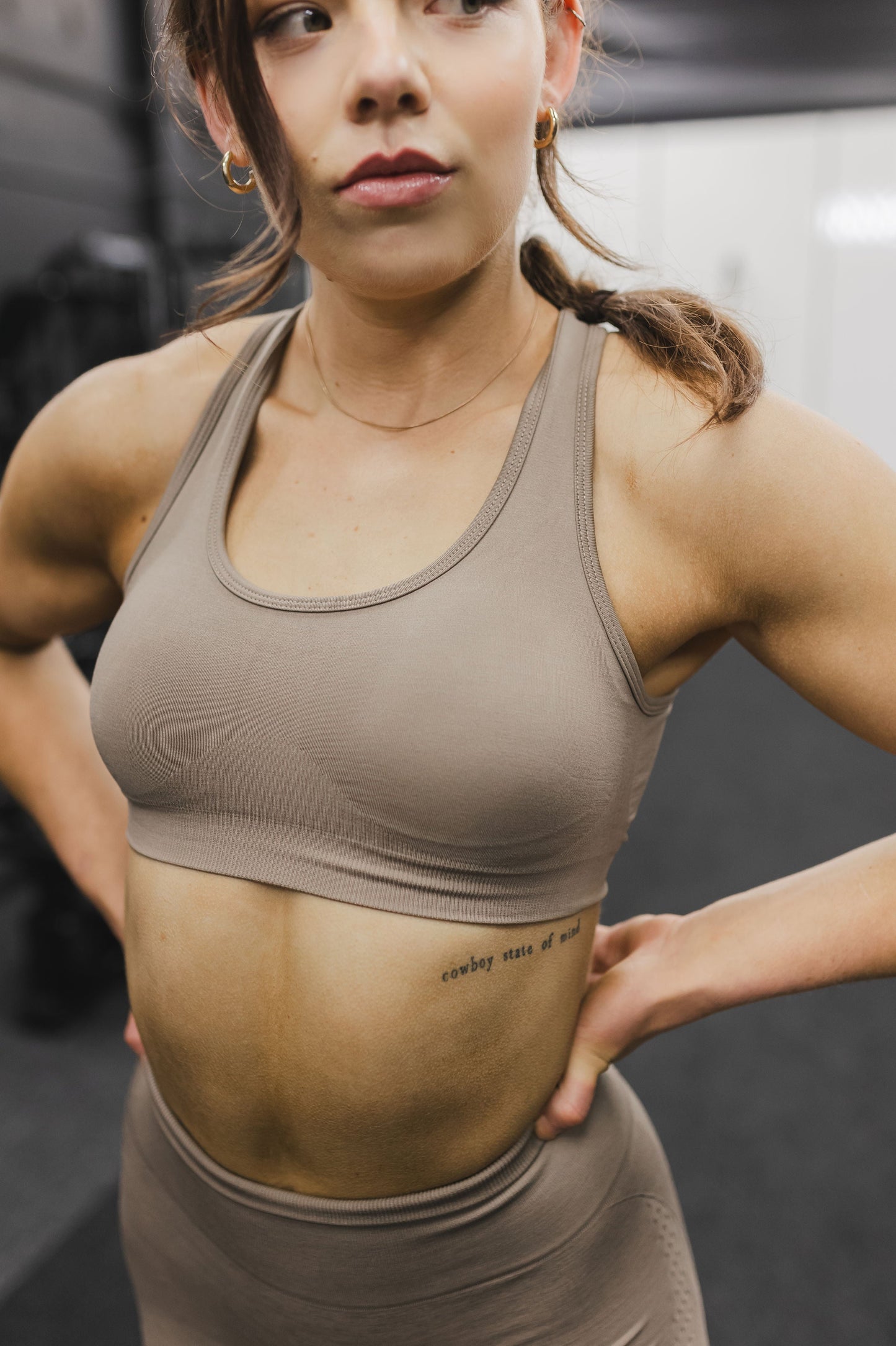 front view of a woman wearing a silhouette seamless sports bra in desert storm with matching leggings for yoga and fitness