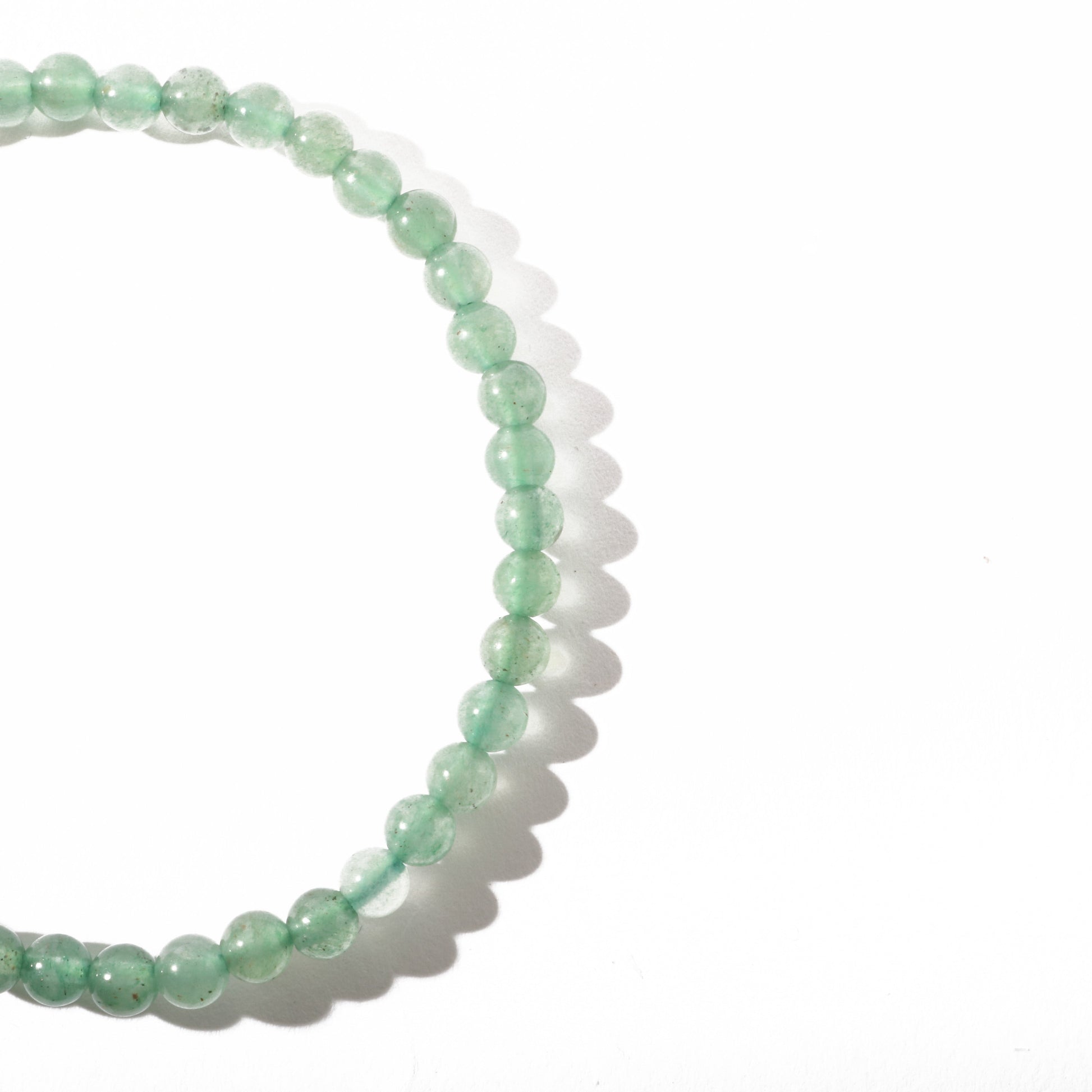 Green aventurine bracelet close-up showing natural shimmering green stone