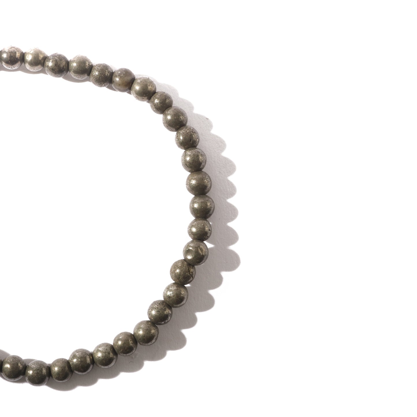Pyrite crystal bracelet worn on wrist for abundance and protection