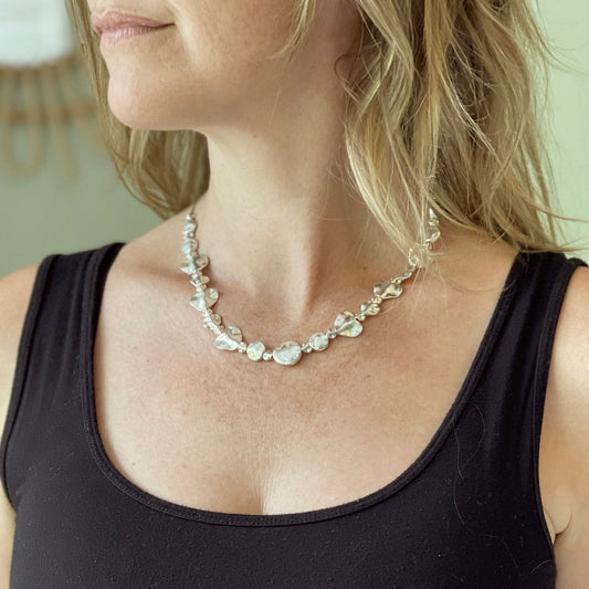 Silver beaten heart necklace Bali handmade artisan jewelry on woman