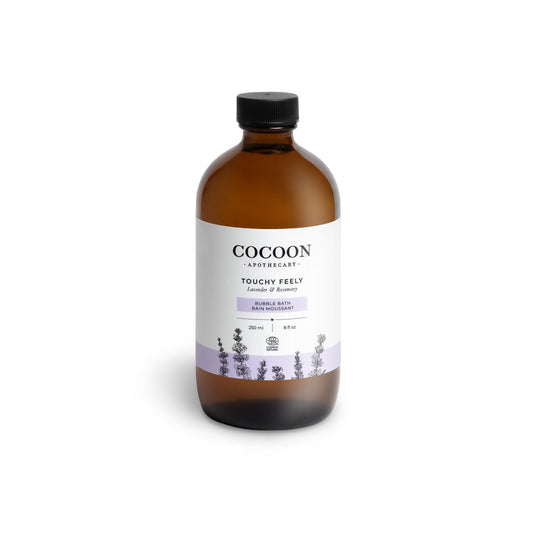 Amber bottle of Cocoon Apothecary Touchy Feely Lavender & Balsam bubble bath on a white background