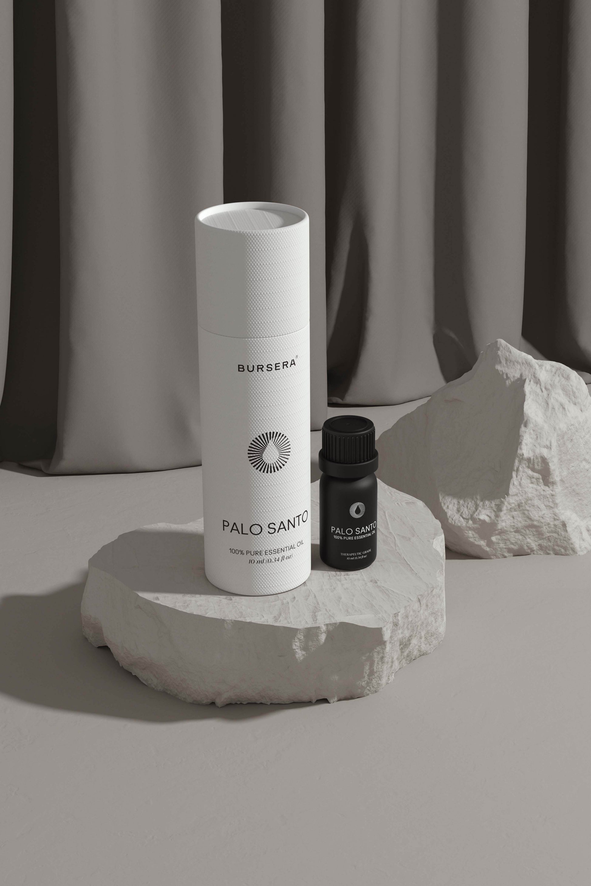 organic palo santo essential oil aromatherapy on a stone surface with a neutral background