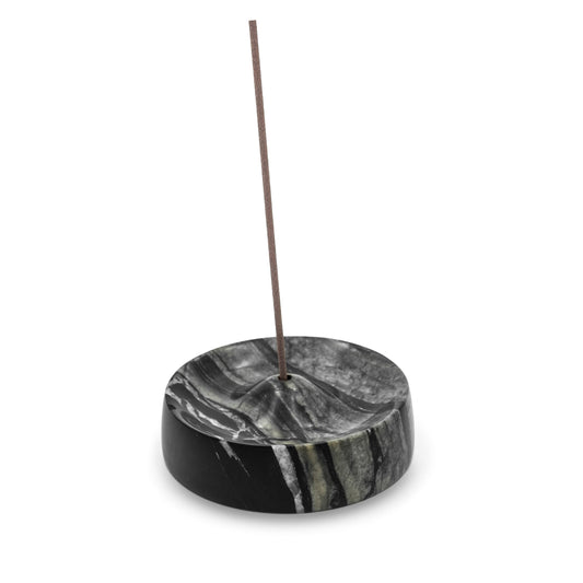 Marble incense holder with a single incense stick on a white background