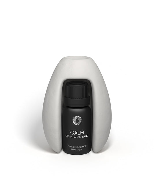 Black essential oil bottle labeled 'Calm' on a white background