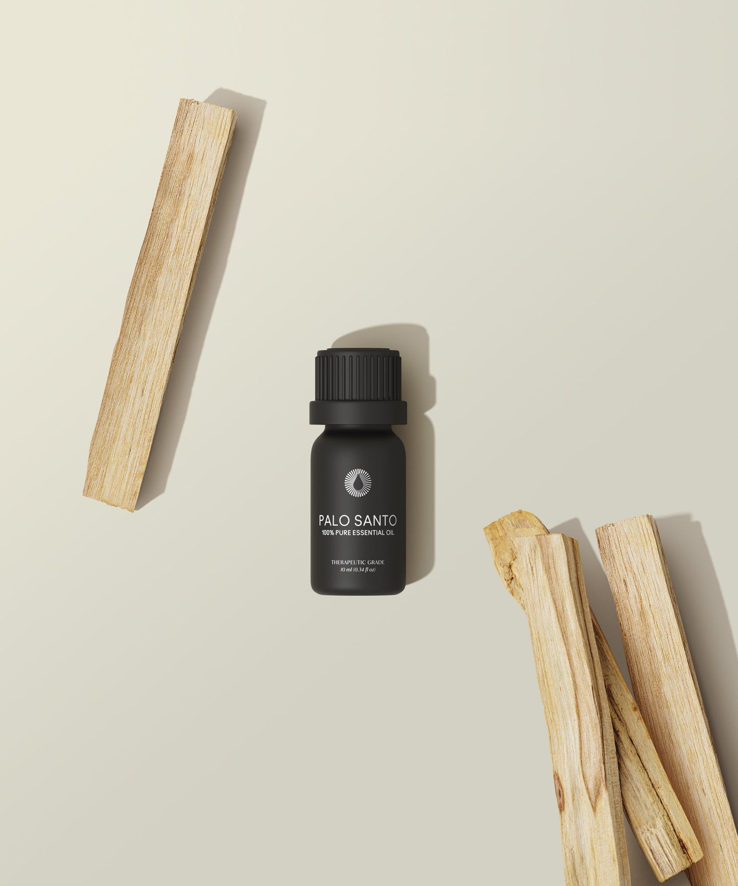 organic palo santo essential oil aromatherapy with wooden sticks on a beige background